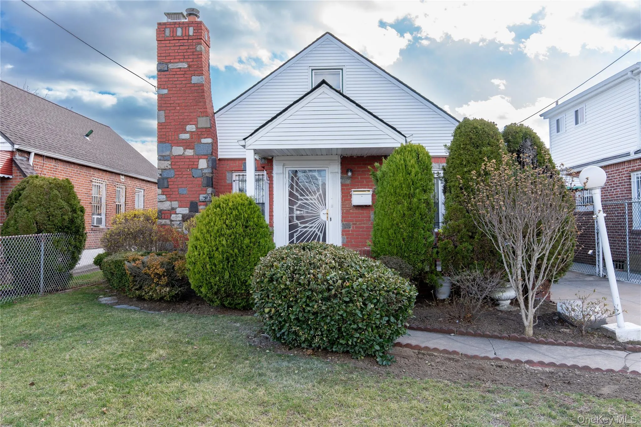 Bungalow with a chimney, brick siding, and a front lawn Bungalow with a chimney, brick siding, and a front lawn