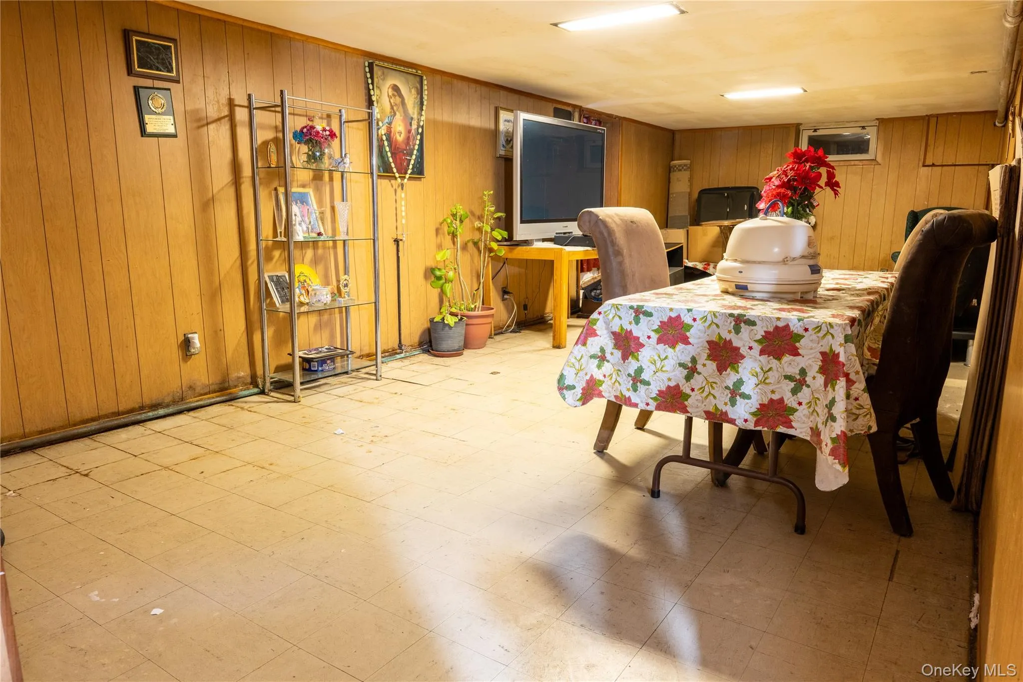 Basement with light flooring and wood walls Basement with light flooring and wood walls