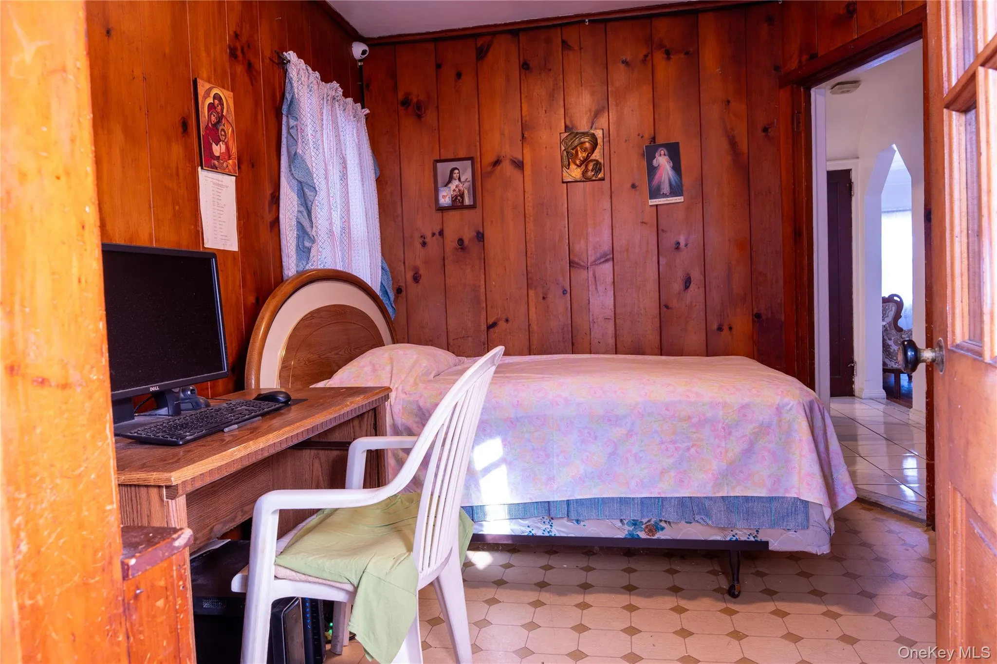 Bedroom featuring tile patterned floors, arched walkways, and an office area Bedroom featuring tile patterned floors, arched walkways, and an office area
