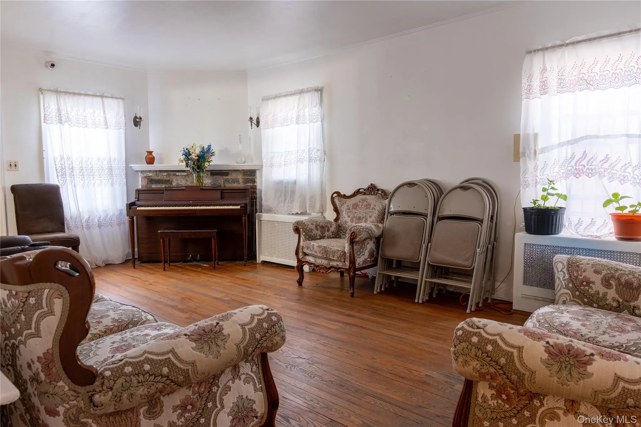 Sitting room with healthy amount of natural light, and wood-style flooring Sitting room with healthy amount of natural light, and wood-style flooring