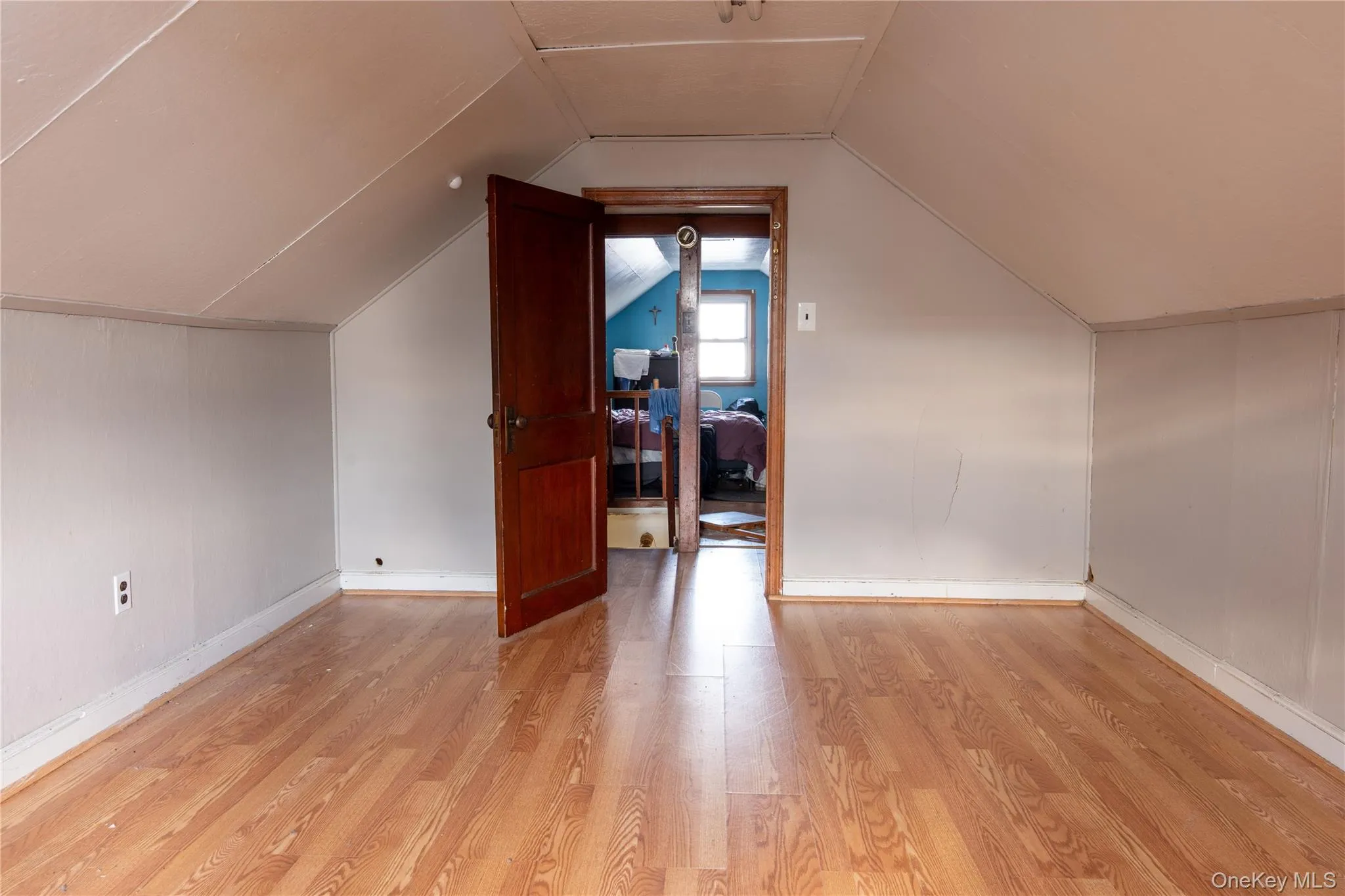 Attic Bonus room with light wood-style floors and baseboards Attic Bonus room with light wood-style floors and baseboards