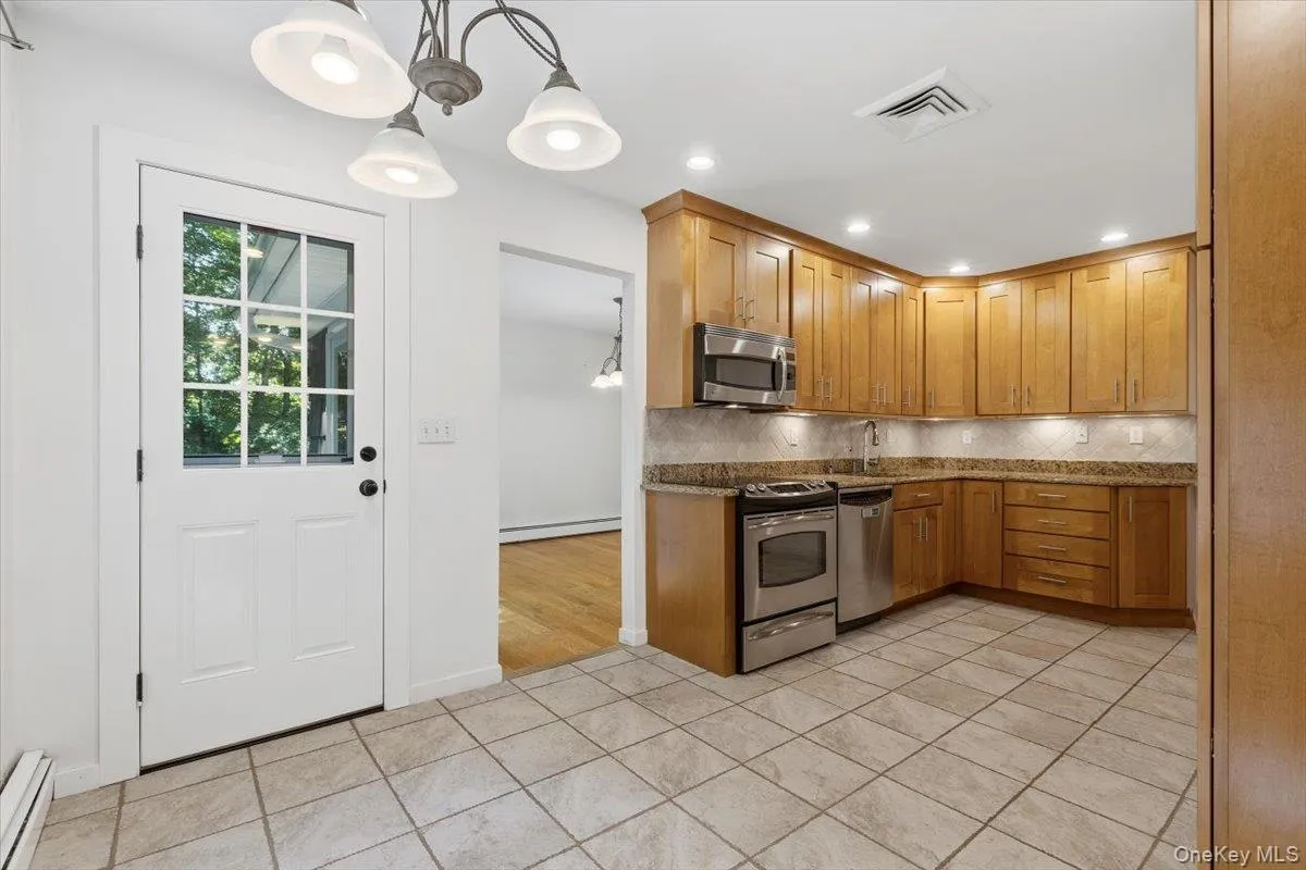 The eating area of the Kitchen also provides a door to the rear Deck for outdoor entertaining and/or dining. The eating area of the Kitchen also provides a door to the rear Deck for outdoor entertaining and/or dining.