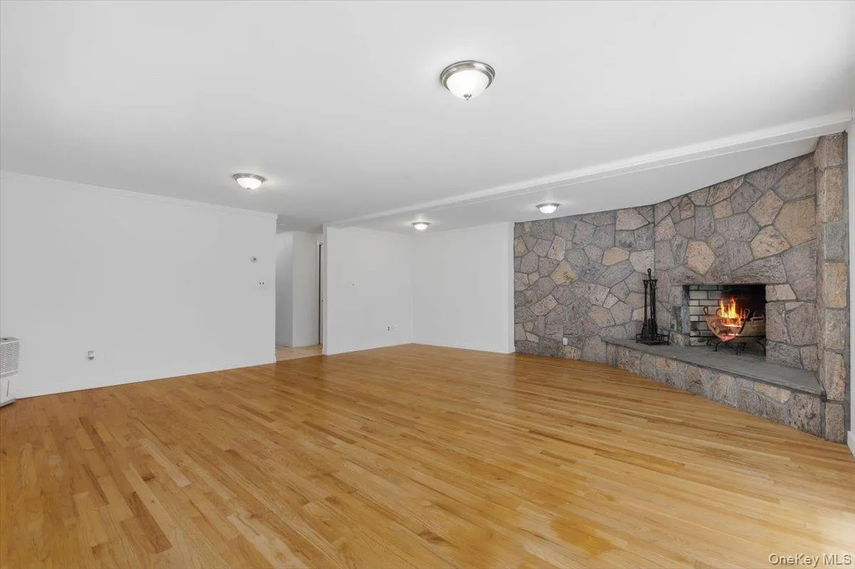 Downstairs to the huge above ground Family/Recreation Room with stone surrounded wood-burning fireplace. Downstairs to the huge above ground Family/Recreation Room with stone surrounded wood-burning fireplace.