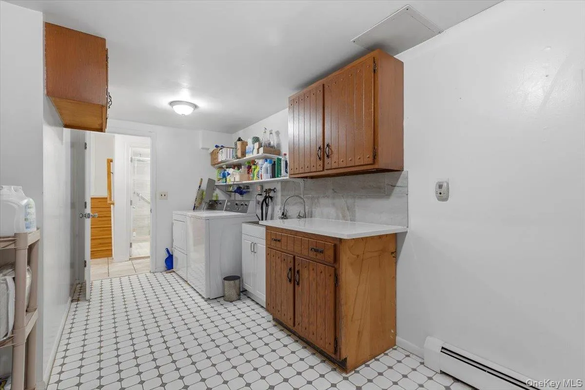 The pristine laundry room on lower level, just inside from the garage. The pristine laundry room on lower level, just inside from the garage.