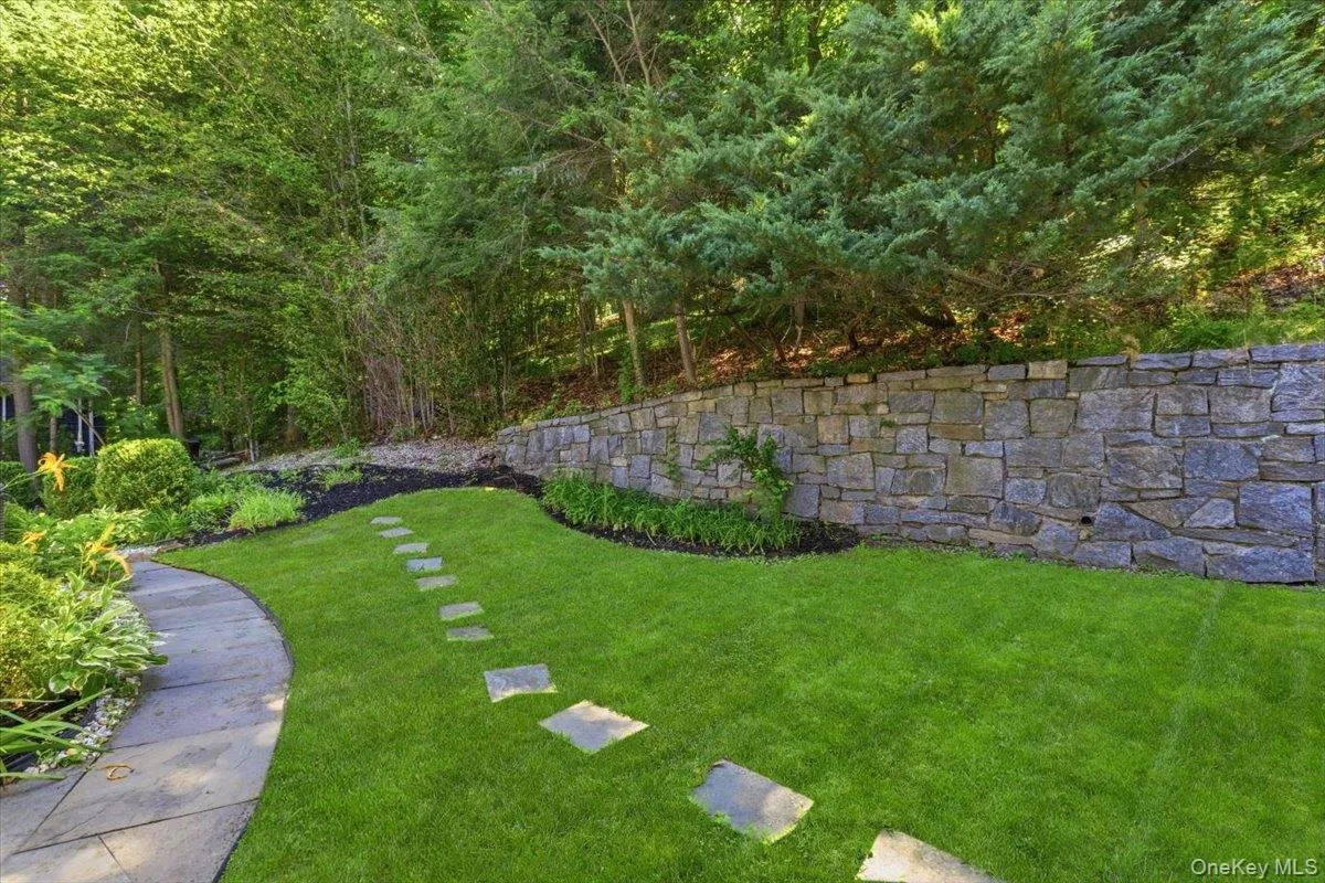 Stroll along the yard path to a beautiful rear garden area. Stroll along the yard path to a beautiful rear garden area.