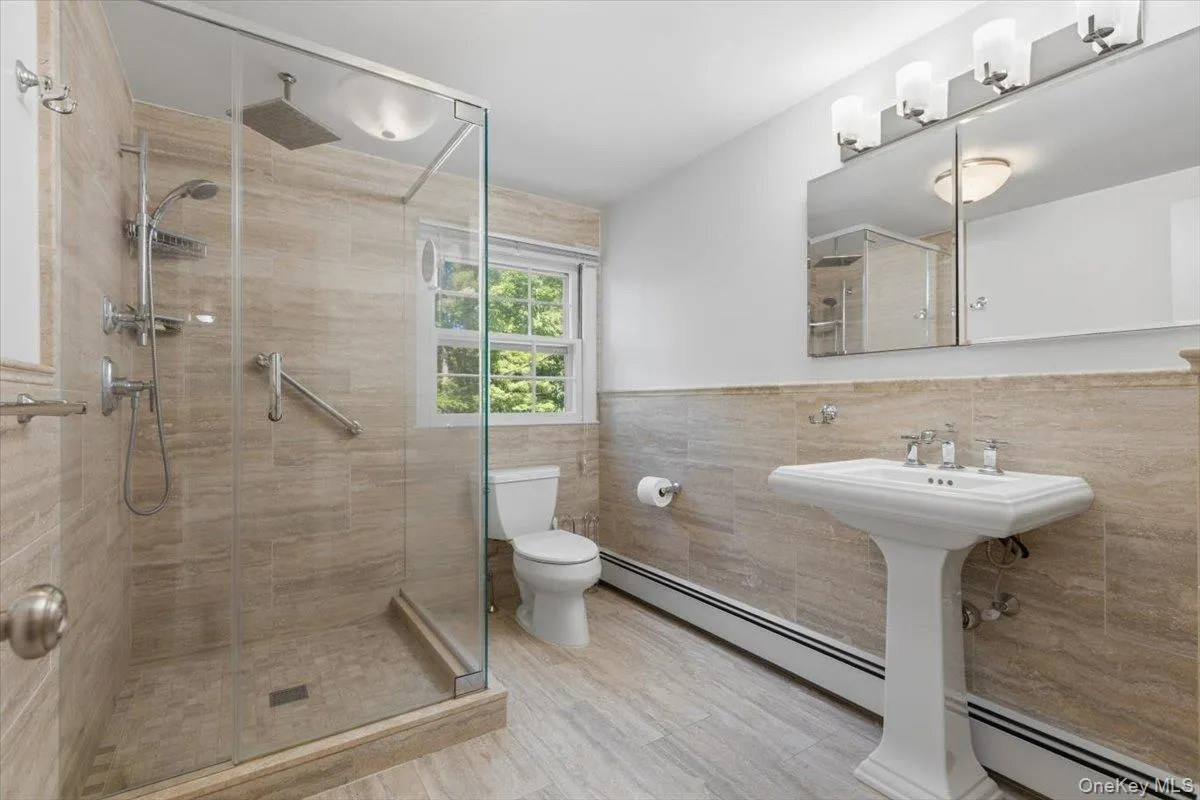 The updated lower level third Full Bathroom with walk- in Shower, provides ease of comfort for lower level guests or when you come home from vacation/sports activities and can step in from the oversized two car garage to wash off. The updated lower level third Full Bathroom with walk- in Shower, provides ease of comfort for lower level guests or when you come home from vacation/sports activities and can step in from the oversized two car garage to wash off.