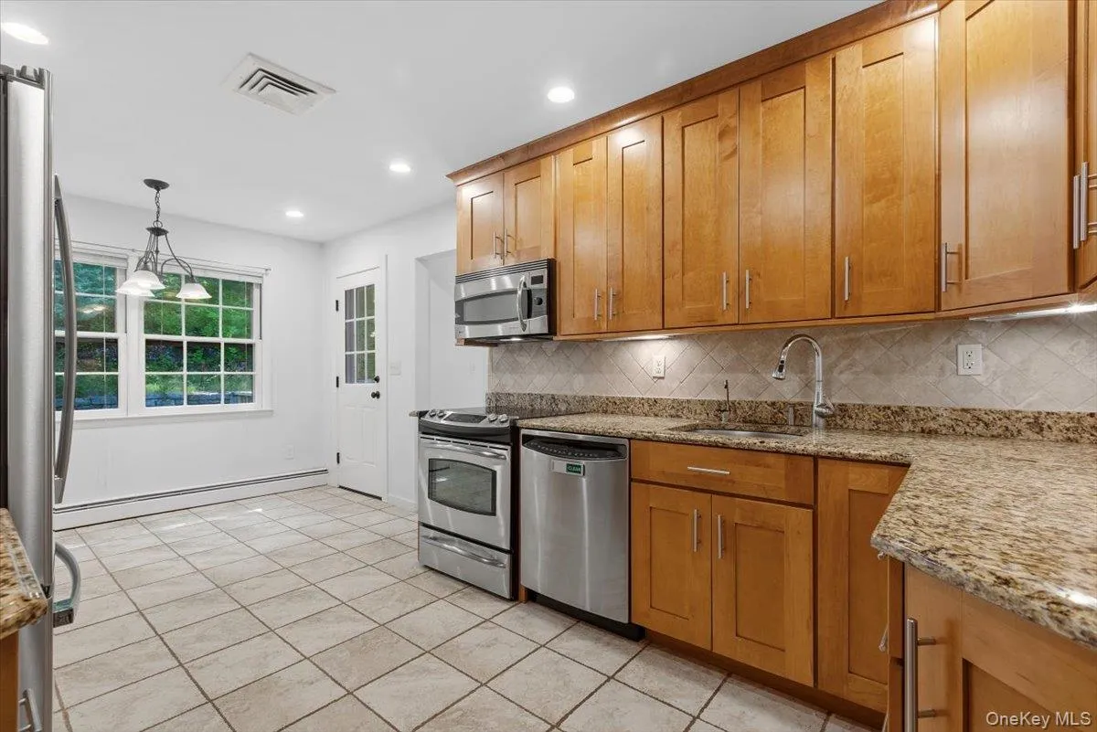 The Kitchen boasts stainless steel appliances including a Refrigerator, Range, Dishwasher and built-in Microwave. The Kitchen boasts stainless steel appliances including a Refrigerator, Range, Dishwasher and built-in Microwave.