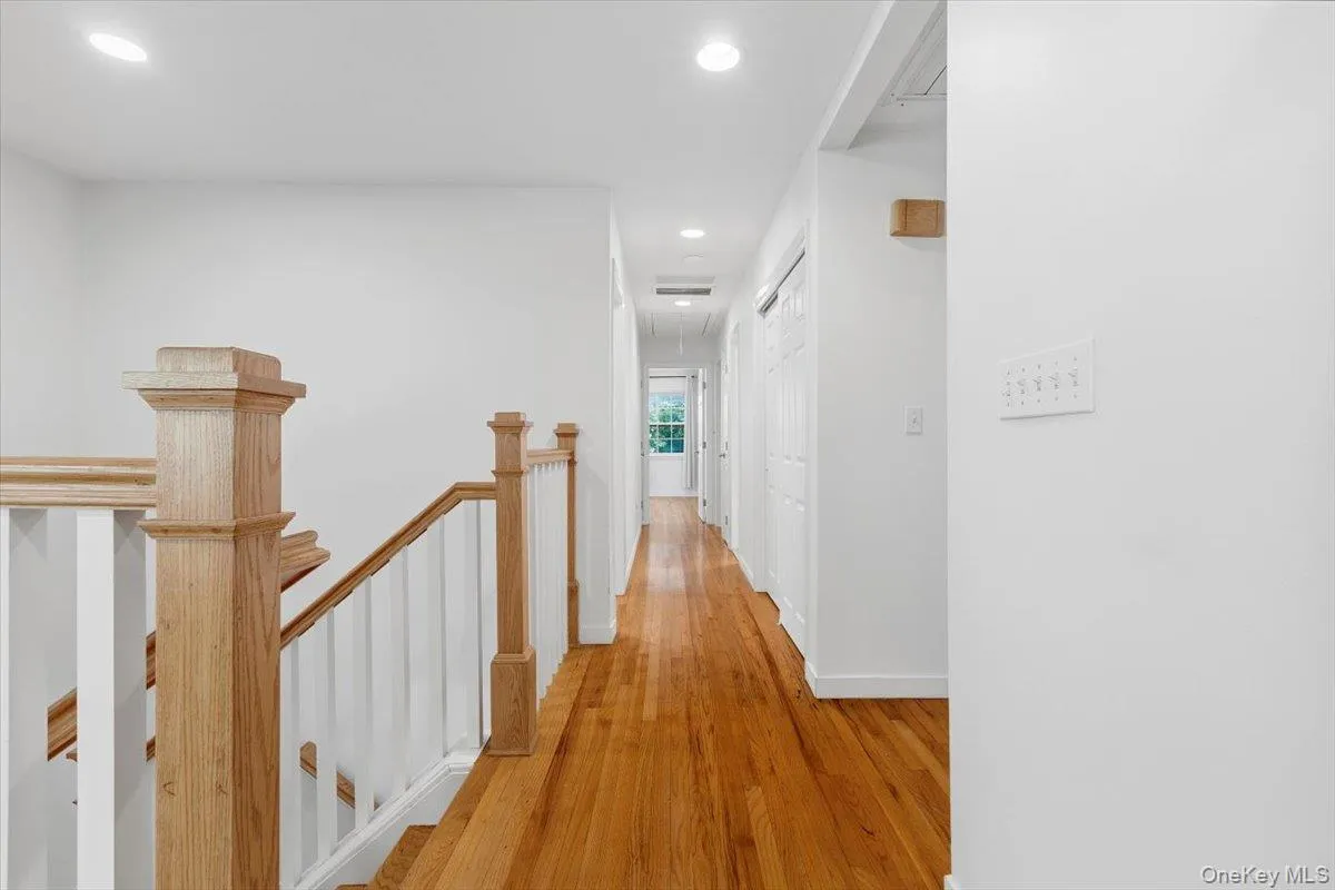 A view from the main floor hallway towards the bedroom wing with four bedrooms, two bathrooms, loads of closets & hardwood floors throughout this level. A view from the main floor hallway towards the bedroom wing with four bedrooms, two bathrooms, loads of closets & hardwood floors throughout this level.