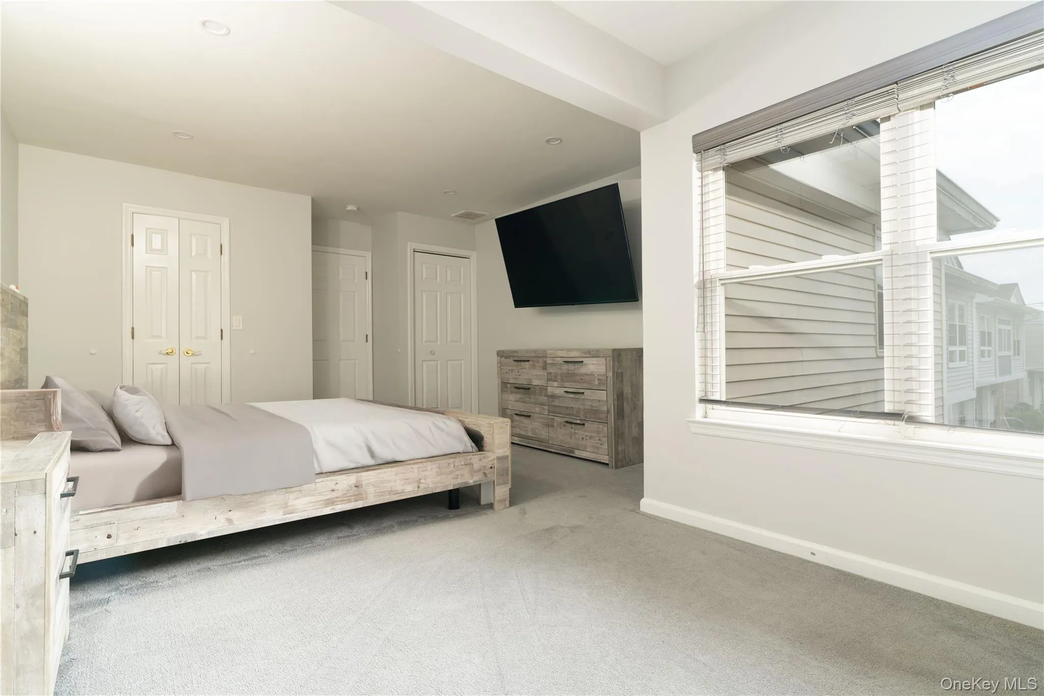 Carpeted bedroom featuring baseboards Carpeted bedroom featuring baseboards