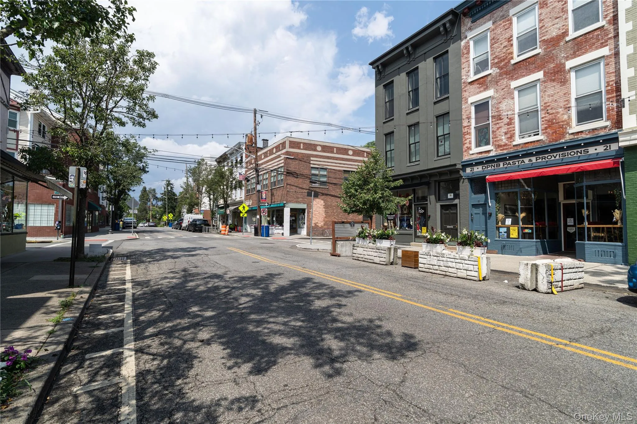 View of asphalt street with sidewalks, curbs, and street lights View of asphalt street with sidewalks, curbs, and street lights