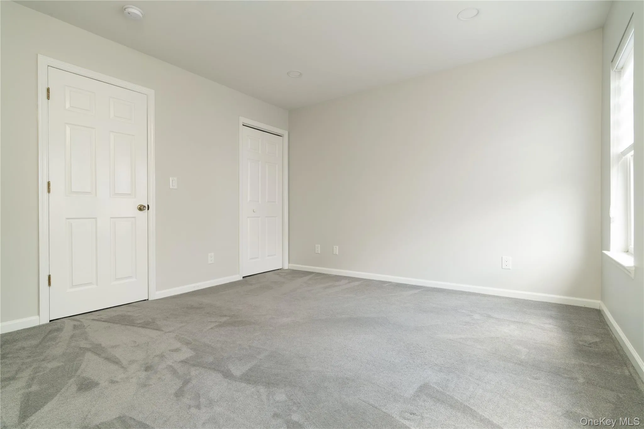Unfurnished bedroom featuring carpet flooring and baseboards Unfurnished bedroom featuring carpet flooring and baseboards