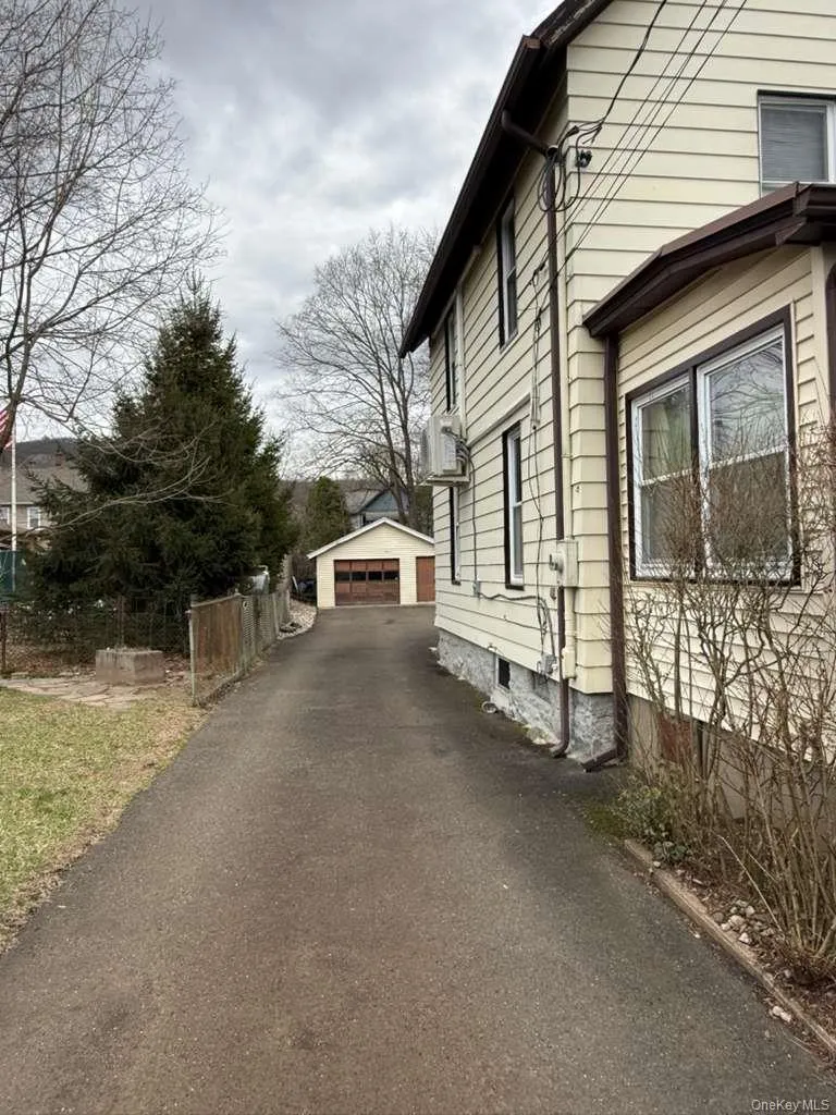 View of home's exterior with a detached garage and an outbuilding View of home's exterior with a detached garage and an outbuilding