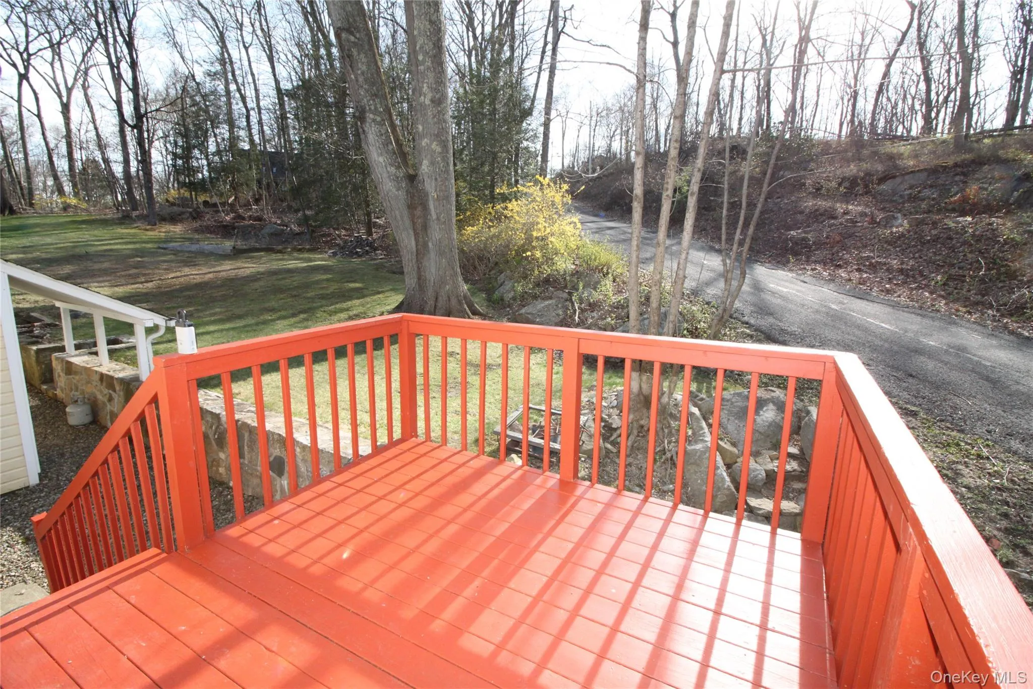 Wooden deck featuring a lawn Wooden deck featuring a lawn