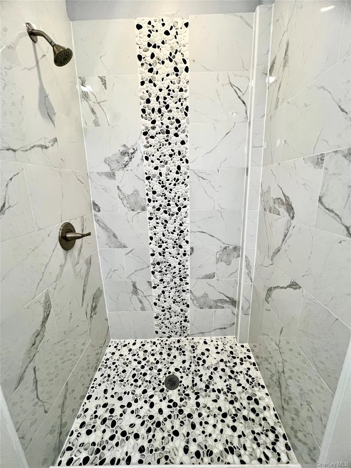 Full bathroom featuring a marble finish shower Full bathroom featuring a marble finish shower