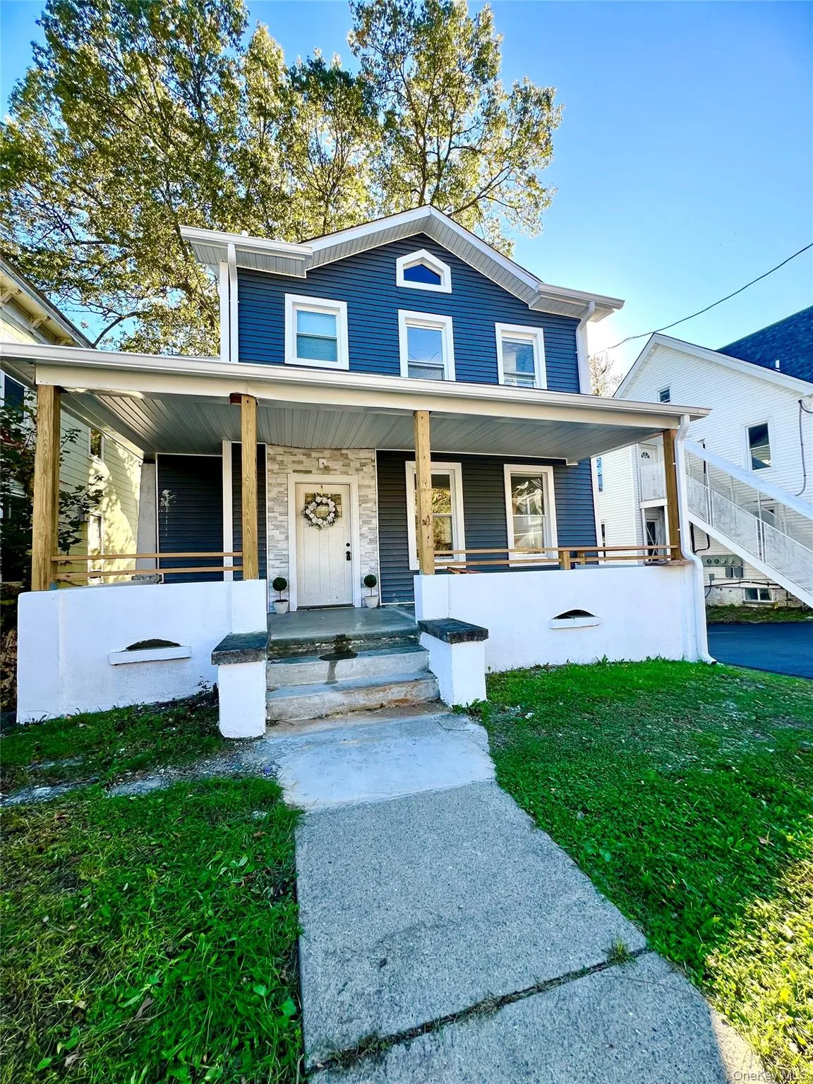 View of front of home with a porch and a front yard View of front of home with a porch and a front yard