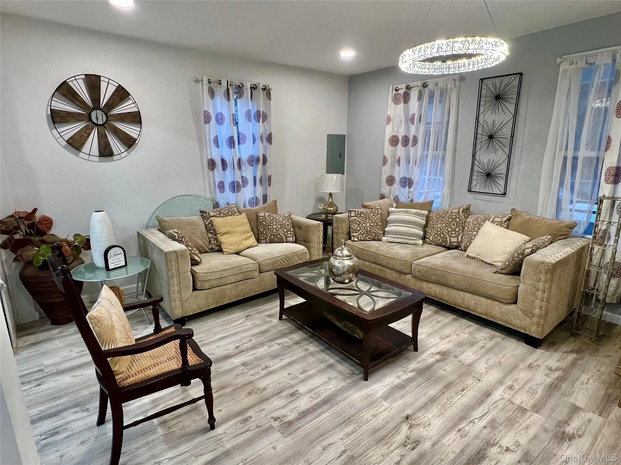 Living room featuring wood finished floors, electric panel, and recessed lighting Living room featuring wood finished floors, electric panel, and recessed lighting