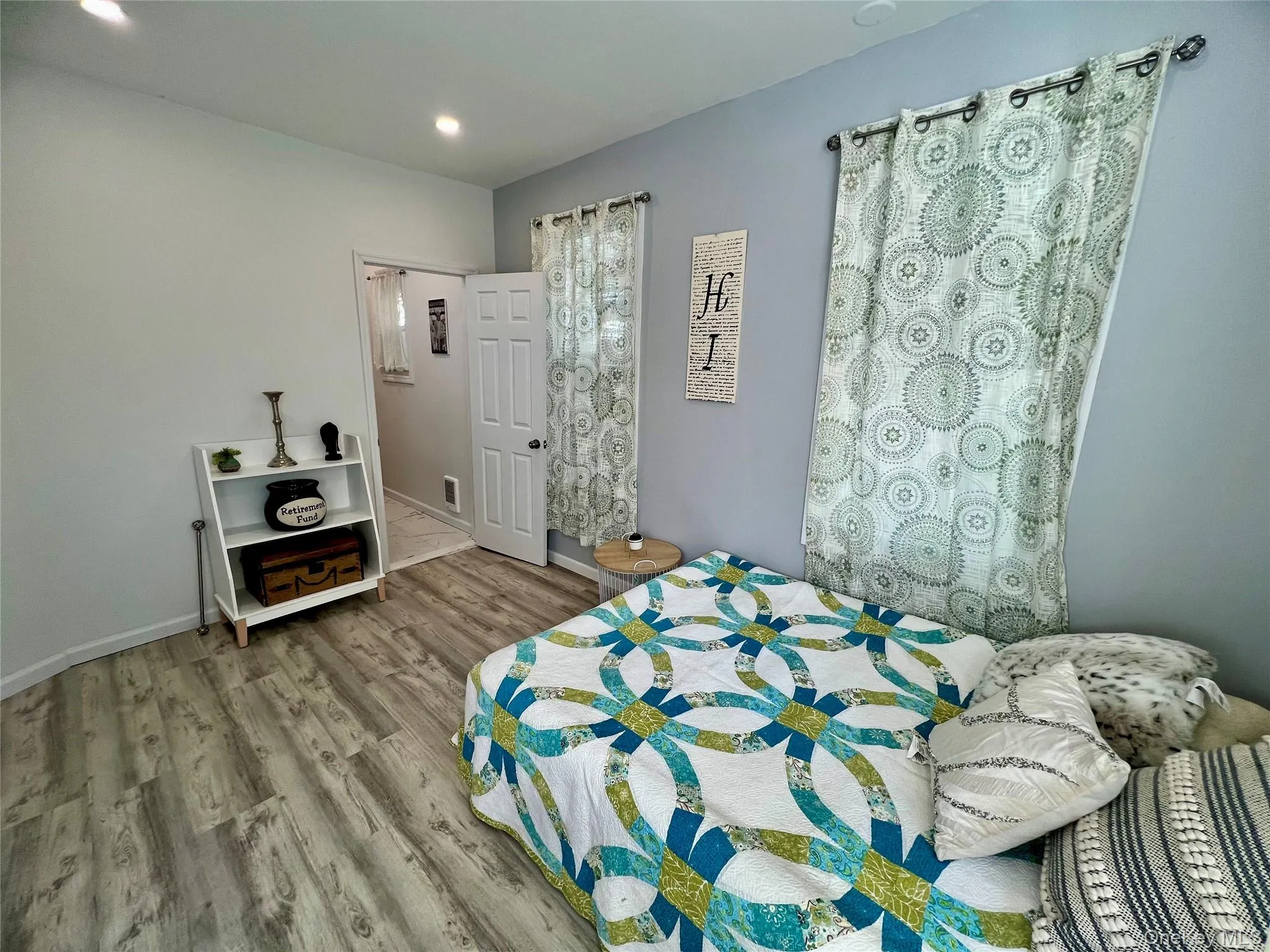 Bedroom with light wood finished floors and recessed lighting Bedroom with light wood finished floors and recessed lighting