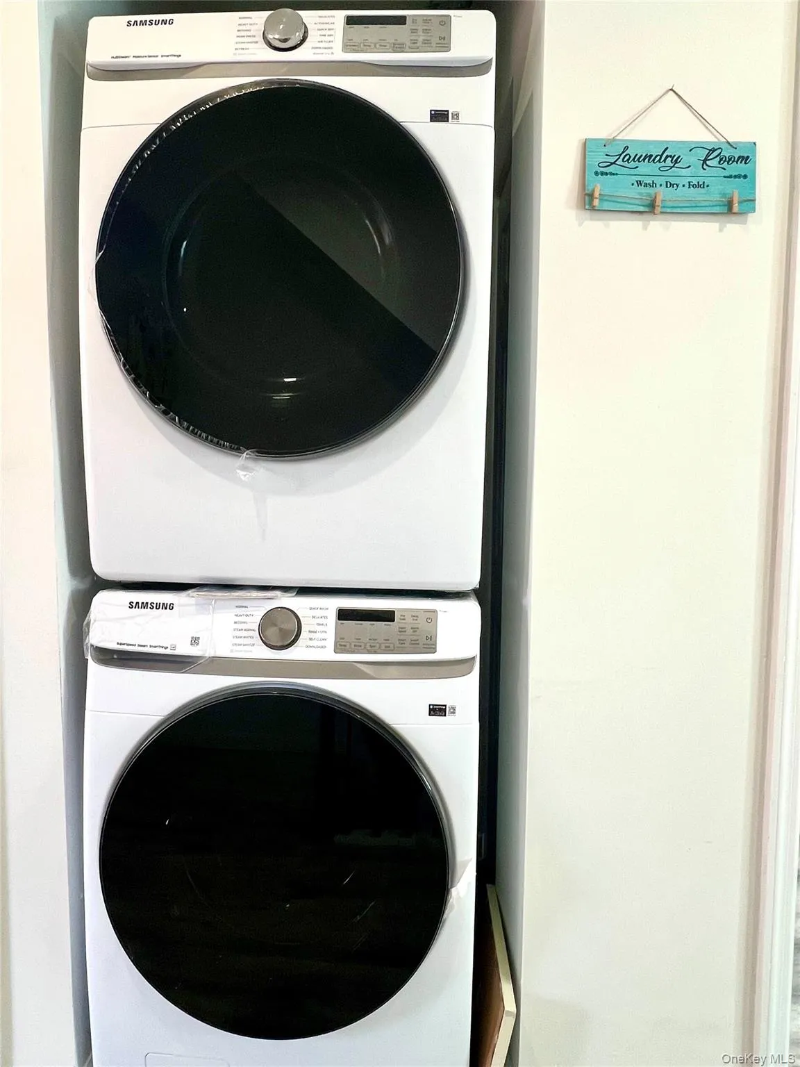 Laundry room with stacked washer and clothes dryer Laundry room with stacked washer and clothes dryer