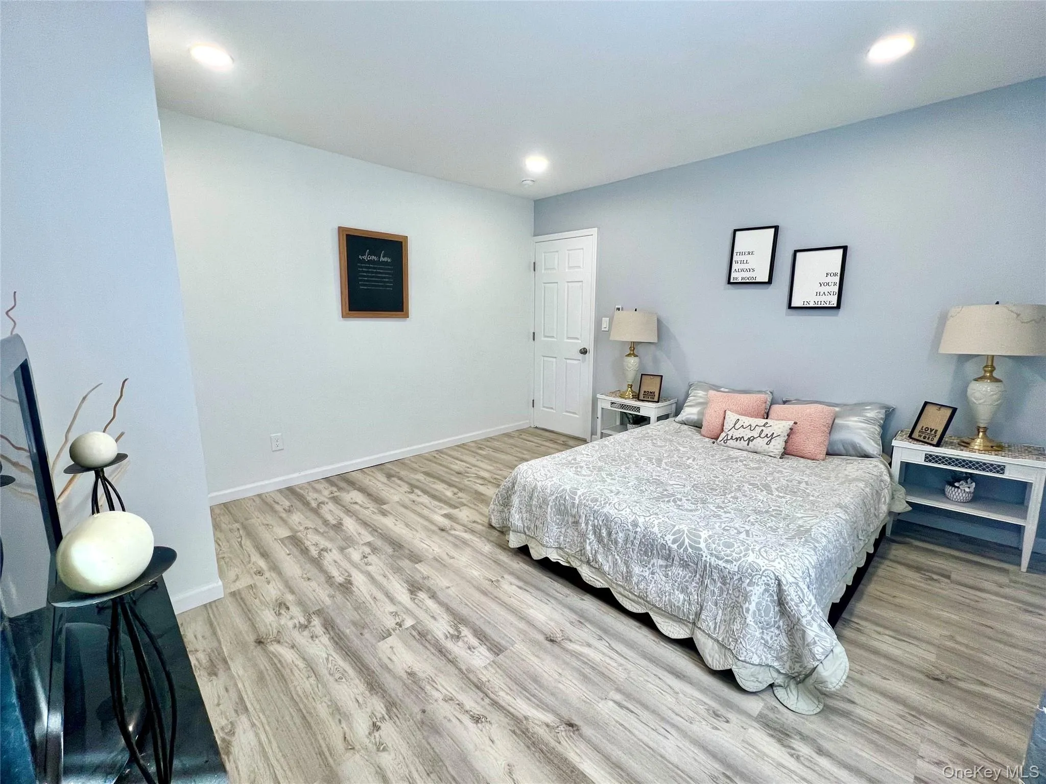 Bedroom featuring recessed lighting and light wood finished floors Bedroom featuring recessed lighting and light wood finished floors