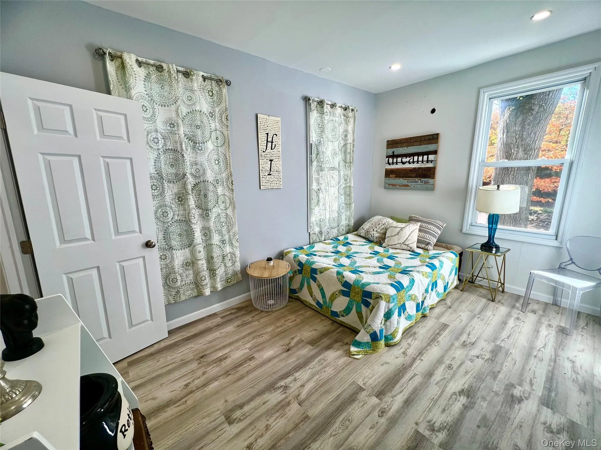 Bedroom with light wood-style floors and recessed lighting Bedroom with light wood-style floors and recessed lighting