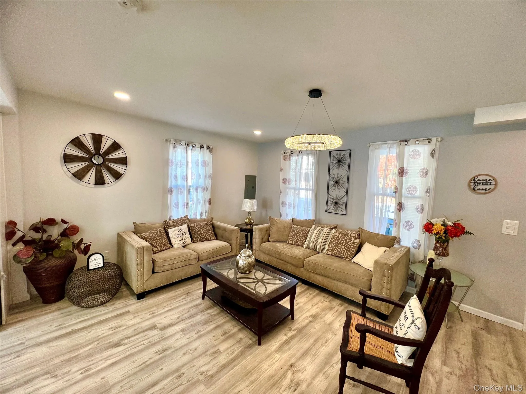 Living area with wood finished floors and recessed lighting Living area with wood finished floors and recessed lighting