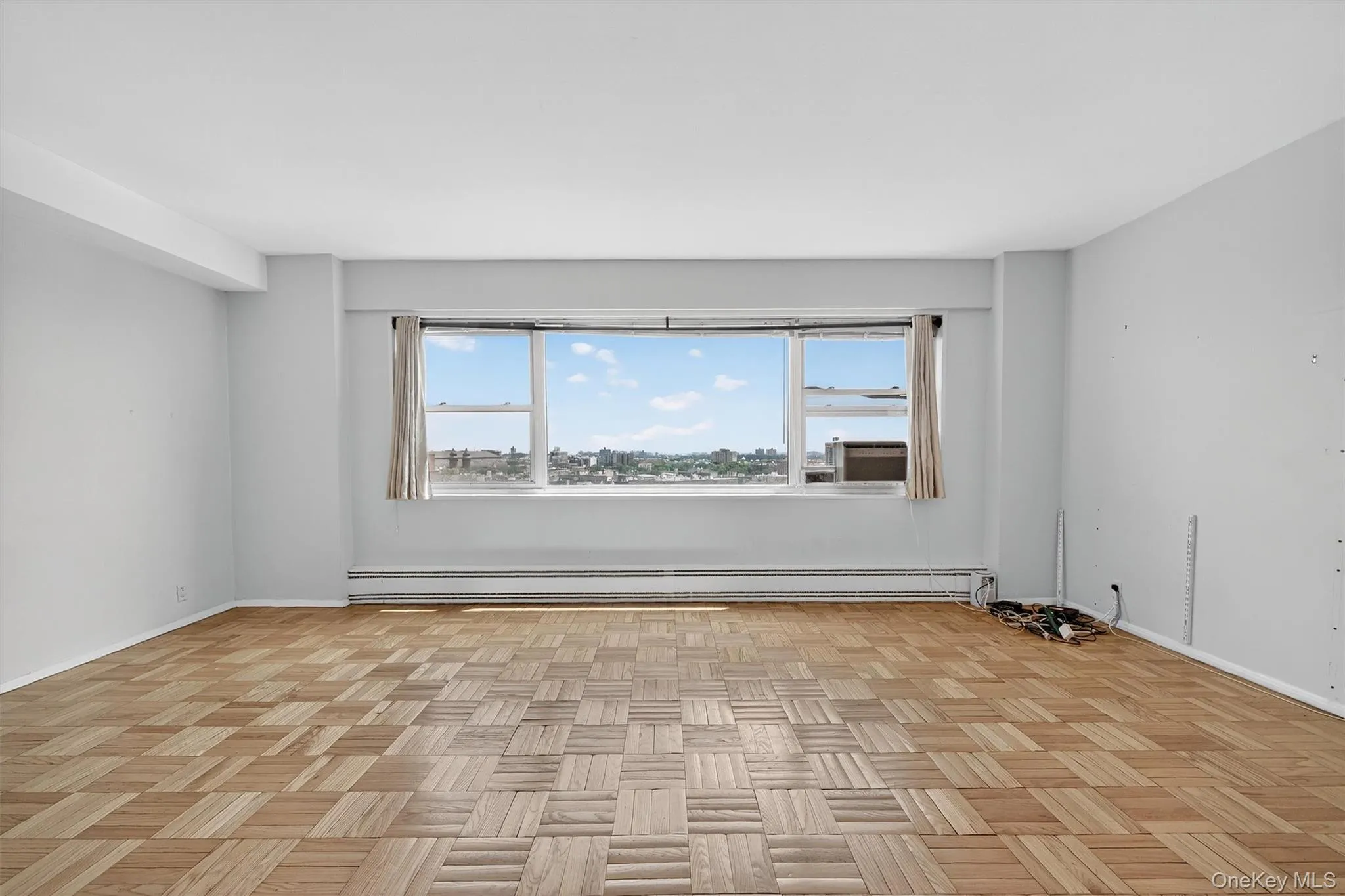 Empty room with baseboard heating and baseboards Empty room with baseboard heating and baseboards