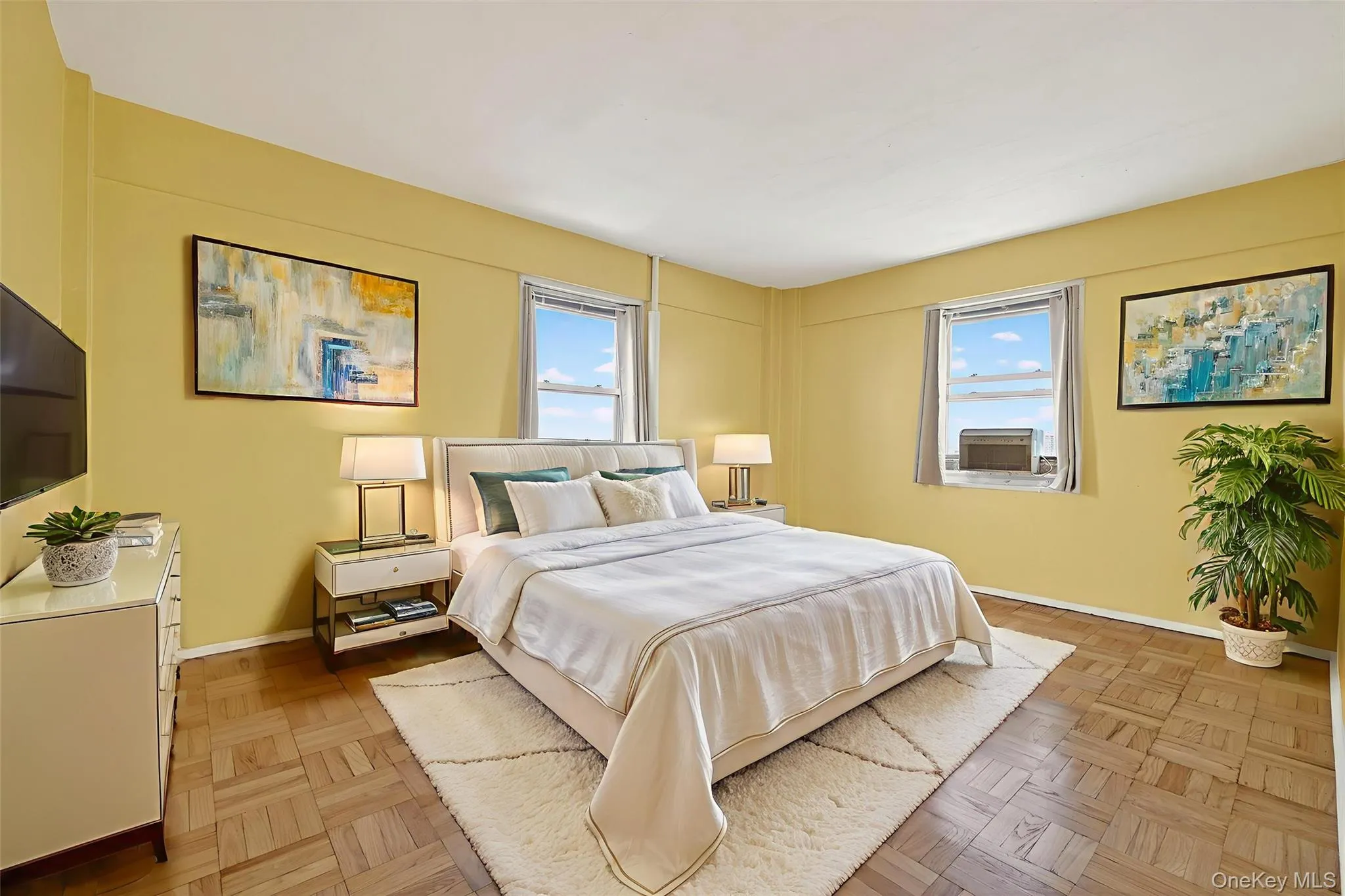 *Virtually Staged* Primary Bedroom with baseboards and cooling unit *Virtually Staged* Primary Bedroom with baseboards and cooling unit