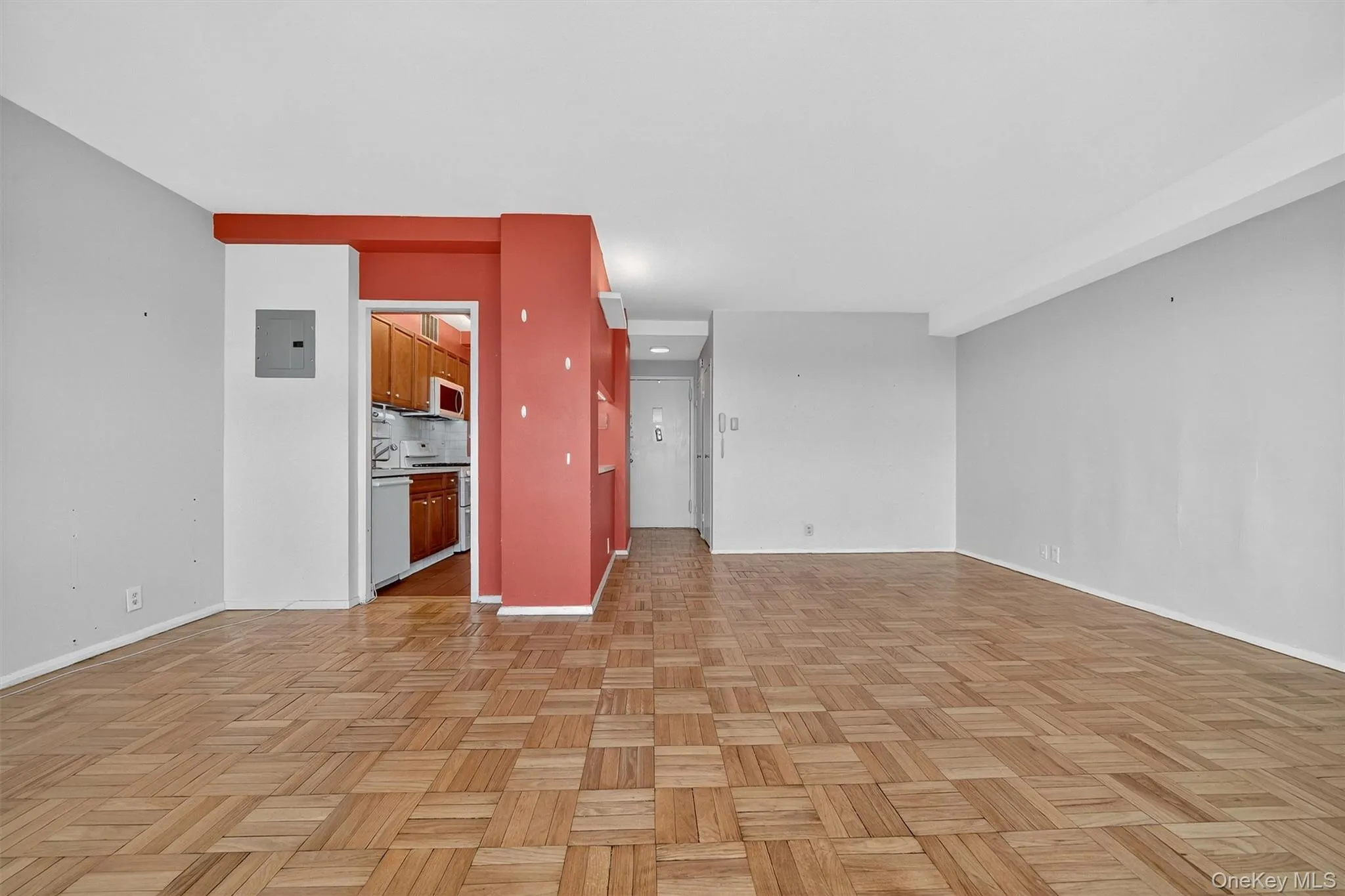 Unfurnished living room with baseboards and electric panel Unfurnished living room with baseboards and electric panel