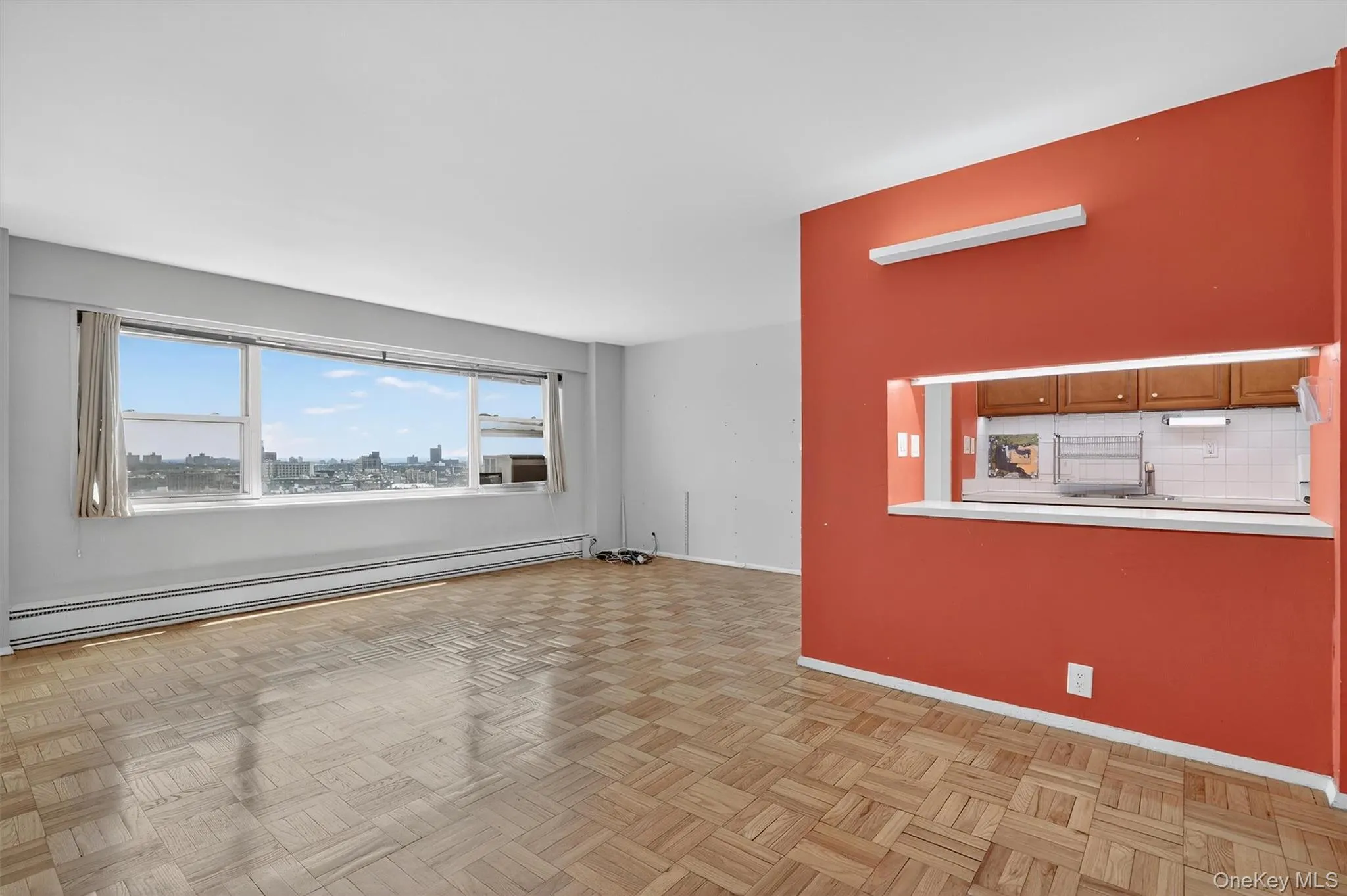 Unfurnished living room with a baseboard radiator and baseboards Unfurnished living room with a baseboard radiator and baseboards