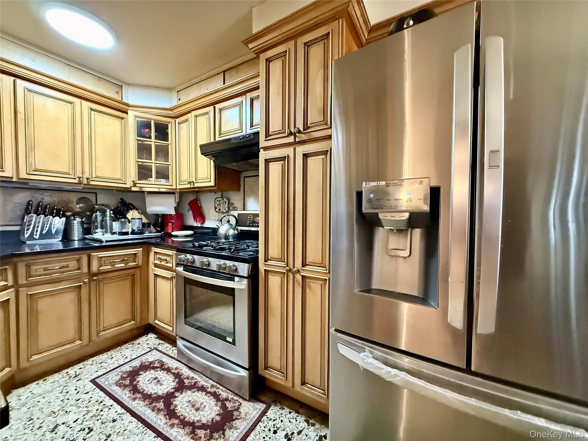 Completely renovated kitchen, light wood cabinets, stainless steel appliances, beautiful marble large tile floor Completely renovated kitchen, light wood cabinets, stainless steel appliances, beautiful marble large tile floor