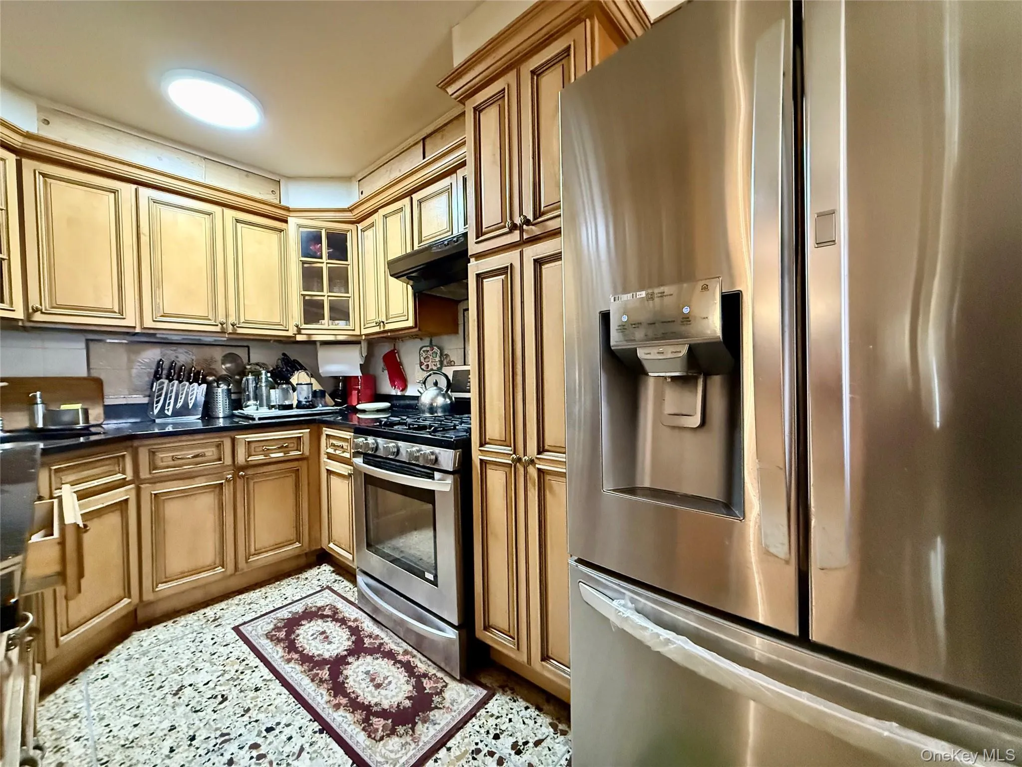 Completely renovated kitchen, light wood cabinets, stainless steel appliances, beautiful marble large tile floor Completely renovated kitchen, light wood cabinets, stainless steel appliances, beautiful marble large tile floor