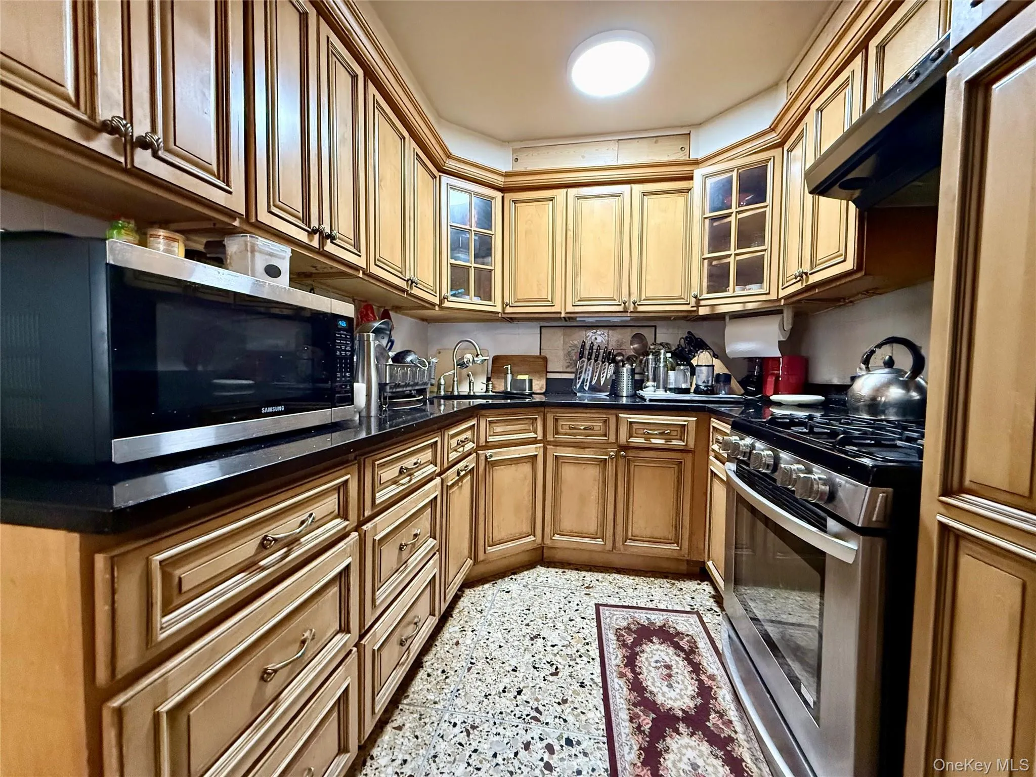 Completely renovated kitchen, light wood cabinets, stainless steel appliances, beautiful marble large tile floor Completely renovated kitchen, light wood cabinets, stainless steel appliances, beautiful marble large tile floor