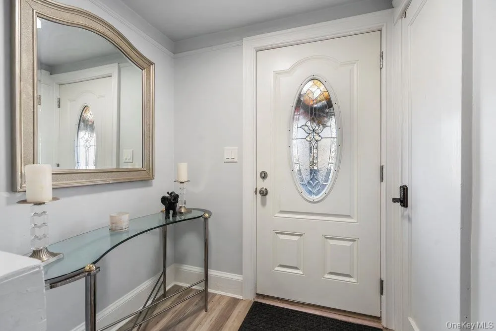 Entrance foyer with light wood-style floors and baseboards Entrance foyer with light wood-style floors and baseboards