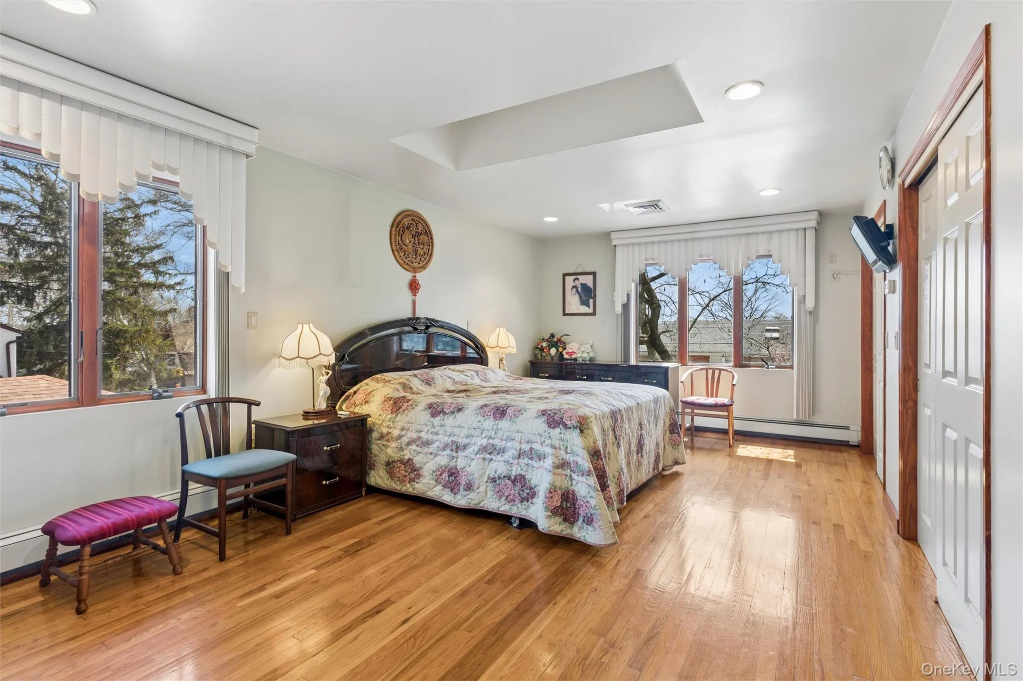 Master Bedroom featuring SkyLight, light wood-style floors, a closet, a baseboard radiator, and recessed lighting Master Bedroom featuring SkyLight, light wood-style floors, a closet, a baseboard radiator, and recessed lighting