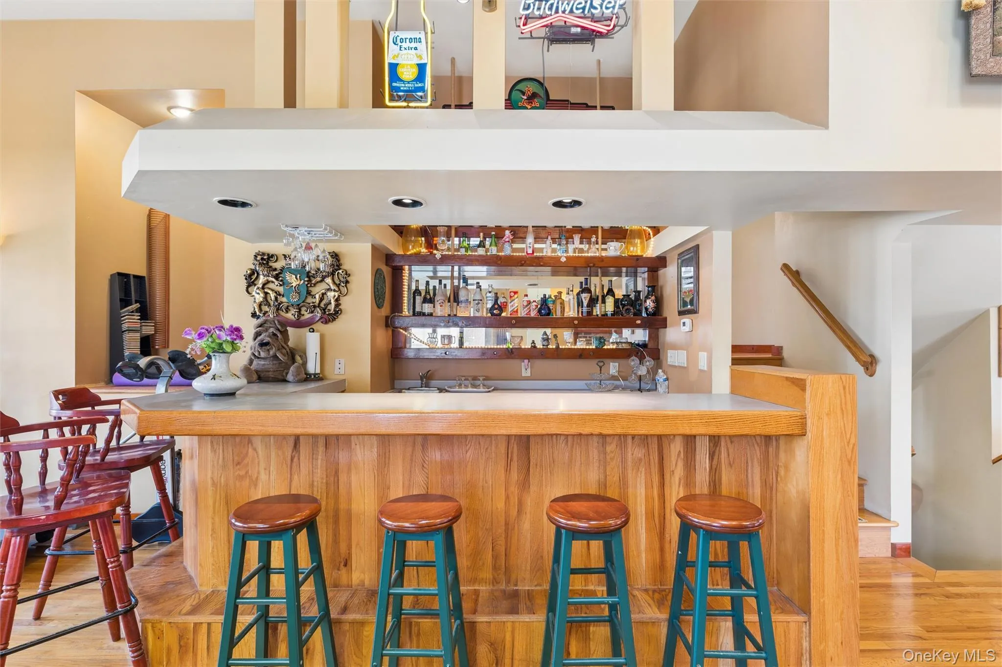 Indoor wet bar featuring light wood-type flooring and open shelves Indoor wet bar featuring light wood-type flooring and open shelves