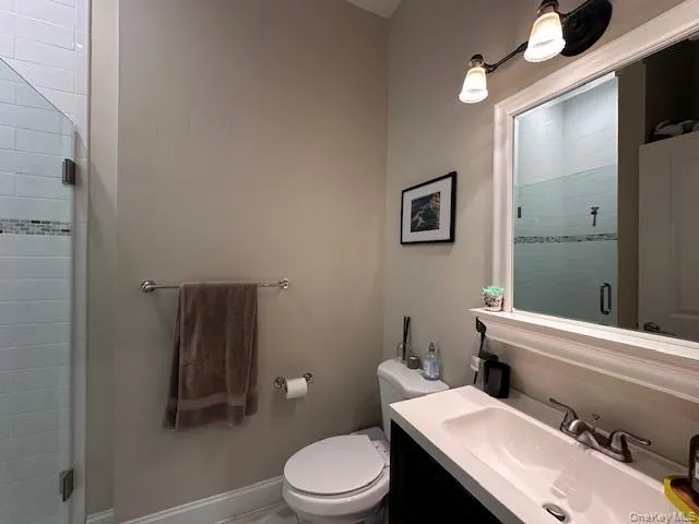 Full bathroom featuring a stall shower and vanity Full bathroom featuring a stall shower and vanity