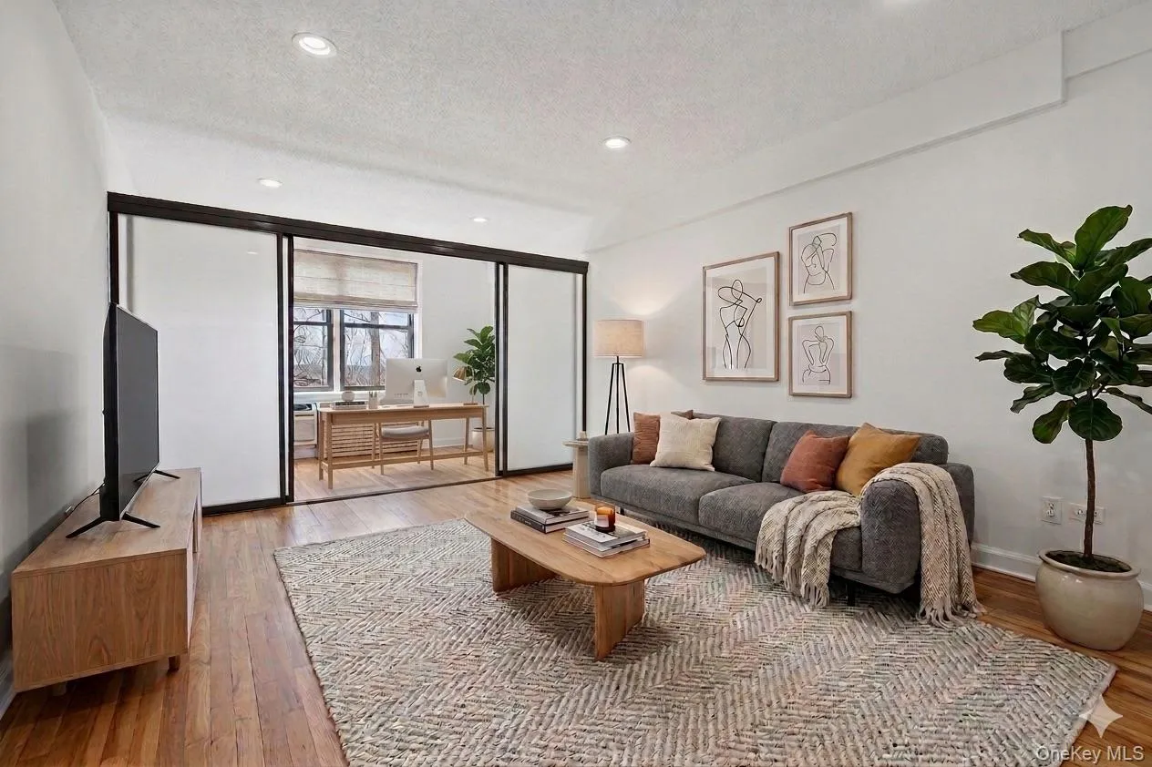 Virtually staged living room with office set up Virtually staged living room with office set up