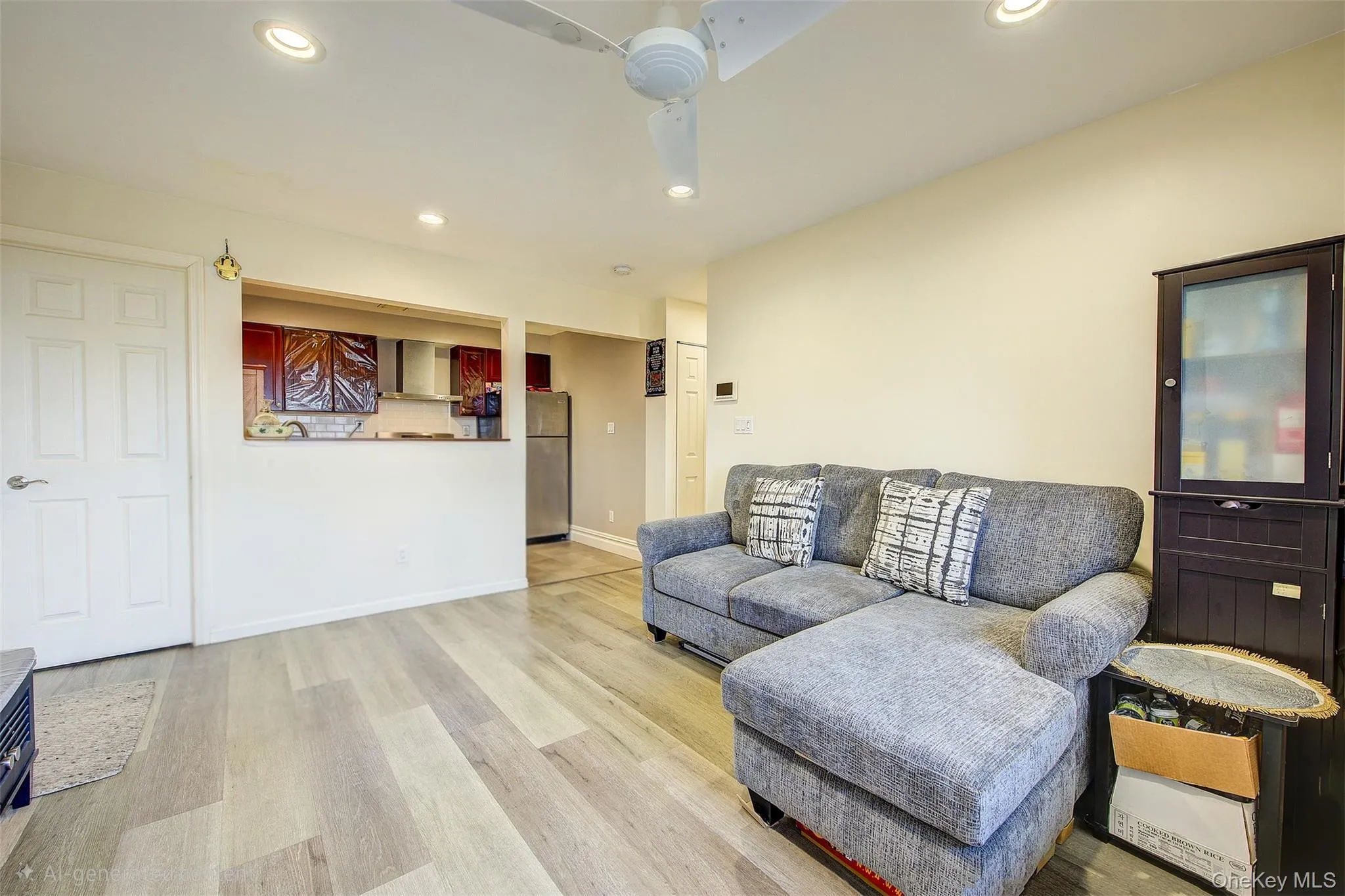 Living area with light wood finished floors, recessed lighting, and ceiling fan Living area with light wood finished floors, recessed lighting, and ceiling fan