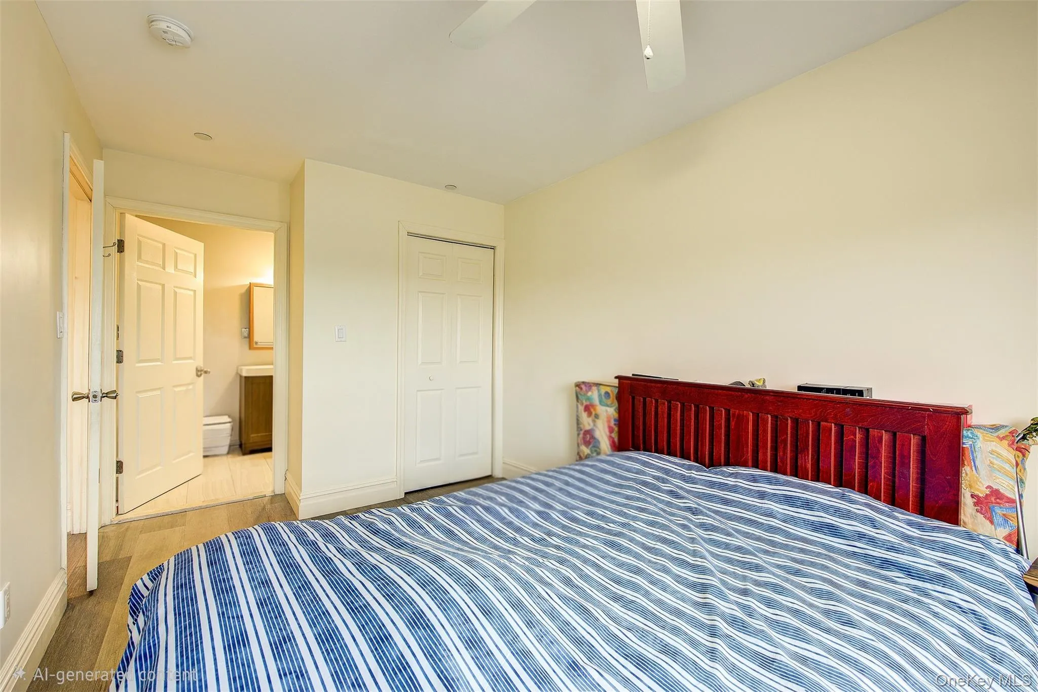 Bedroom featuring a closet, wood finished floors, and ceiling fan Bedroom featuring a closet, wood finished floors, and ceiling fan