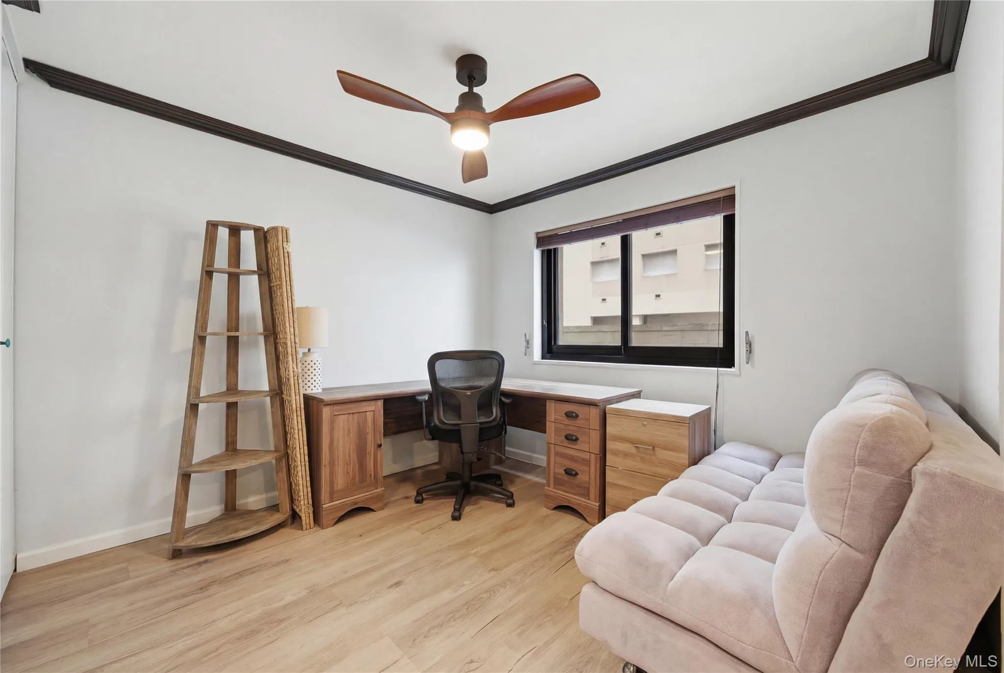 Office space featuring light wood-type flooring, crown molding, and ceiling fan Office space featuring light wood-type flooring, crown molding, and ceiling fan