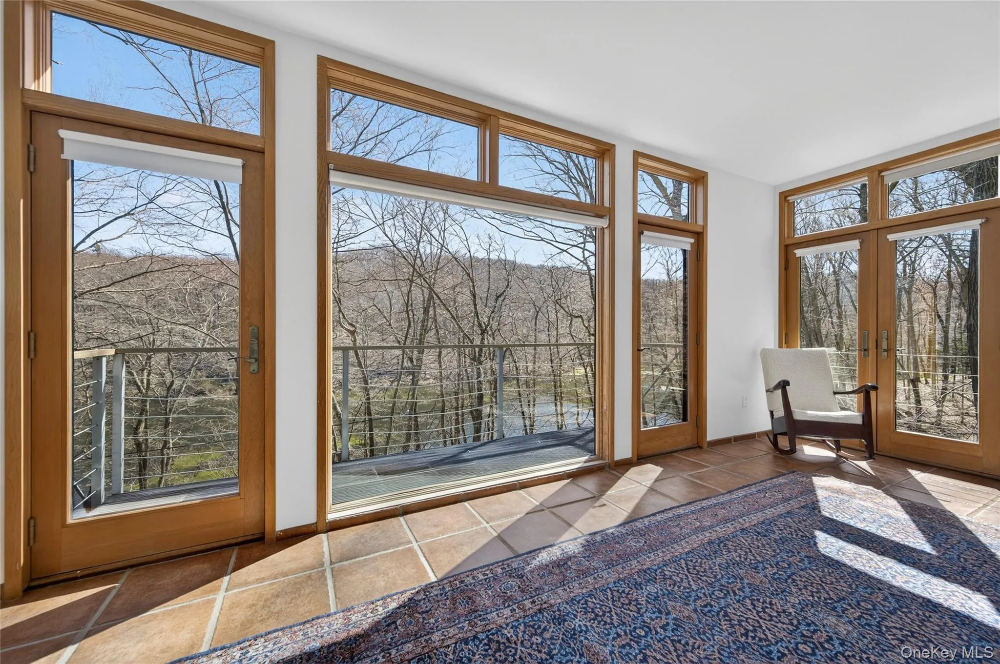 Expansive windows and glass doors frame the wooded landscape Expansive windows and glass doors frame the wooded landscape