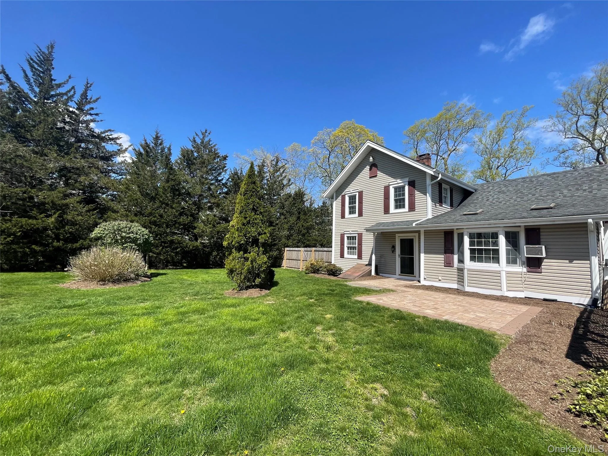 View of grassy yard featuring a patio area View of grassy yard featuring a patio area