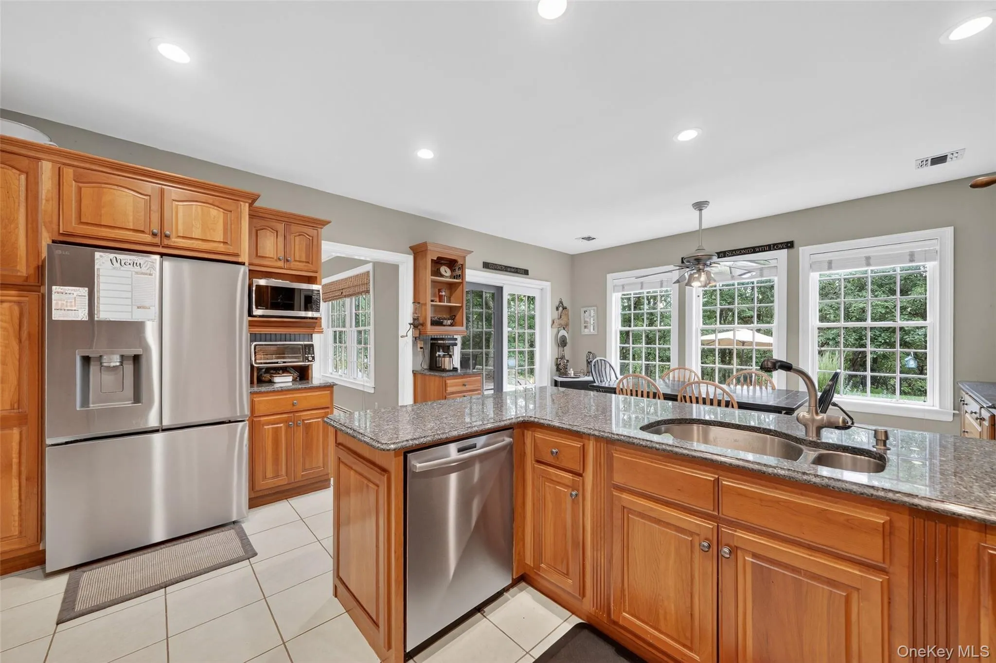 Kitchen featuring appliances with stainless steel finishes, stone counters, plenty of natural light, and recessed lighting Kitchen featuring appliances with stainless steel finishes, stone counters, plenty of natural light, and recessed lighting