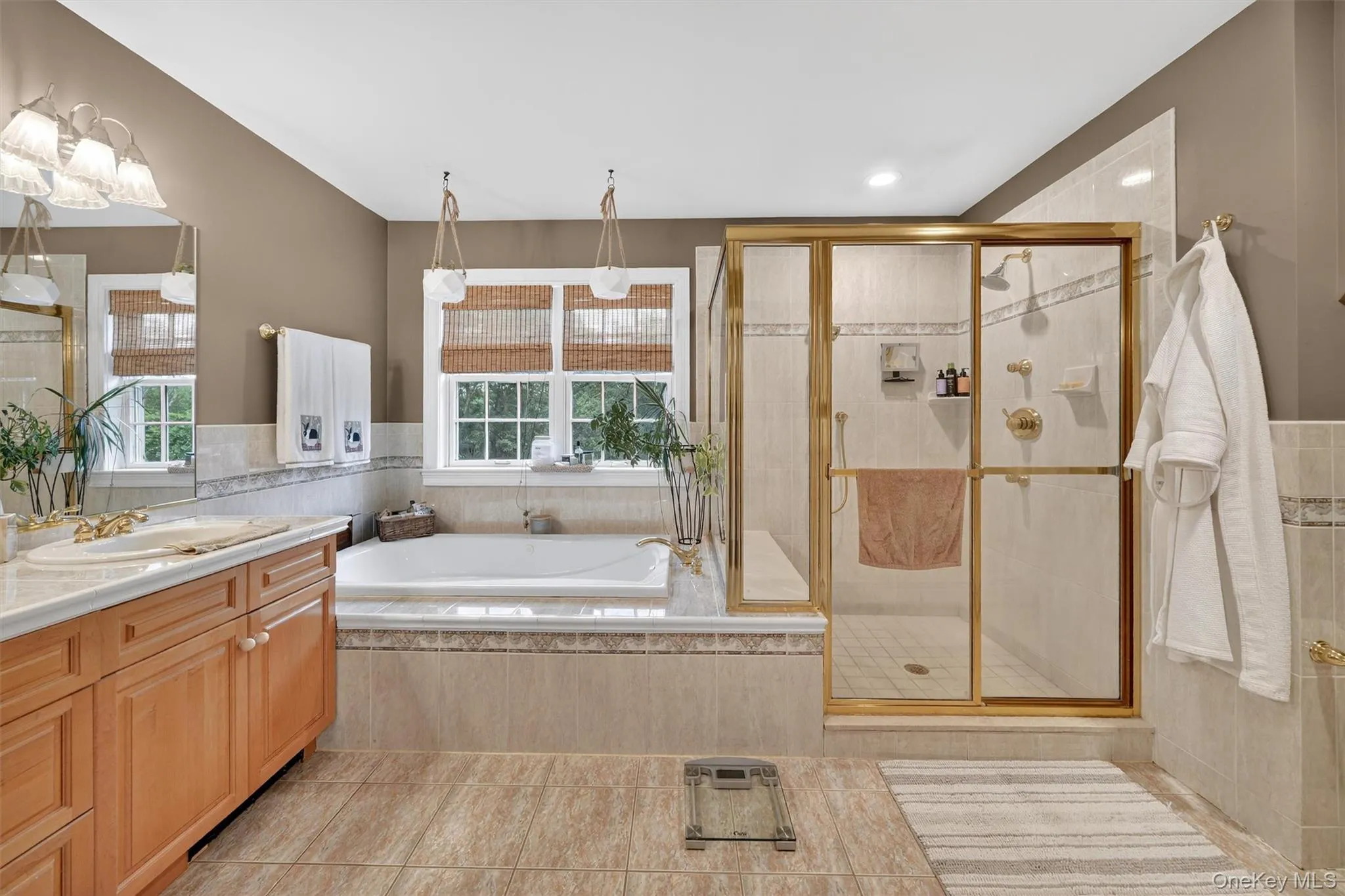 Full bath with vanity, a bath, tile patterned floors, and a stall shower Full bath with vanity, a bath, tile patterned floors, and a stall shower