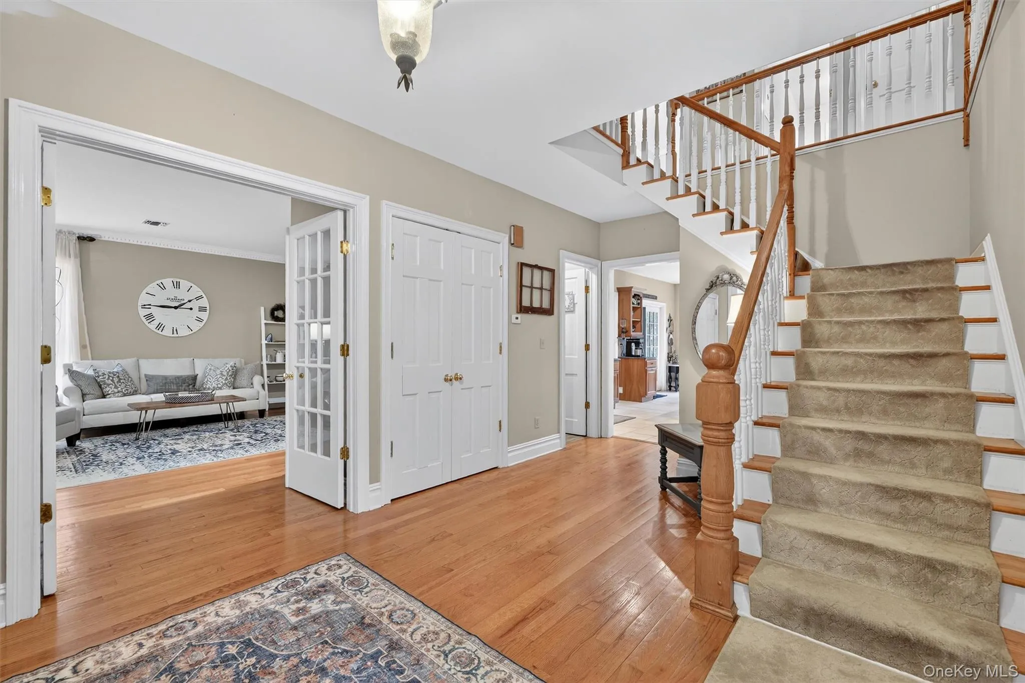 Entrance foyer with stairway and wood finished floors Entrance foyer with stairway and wood finished floors