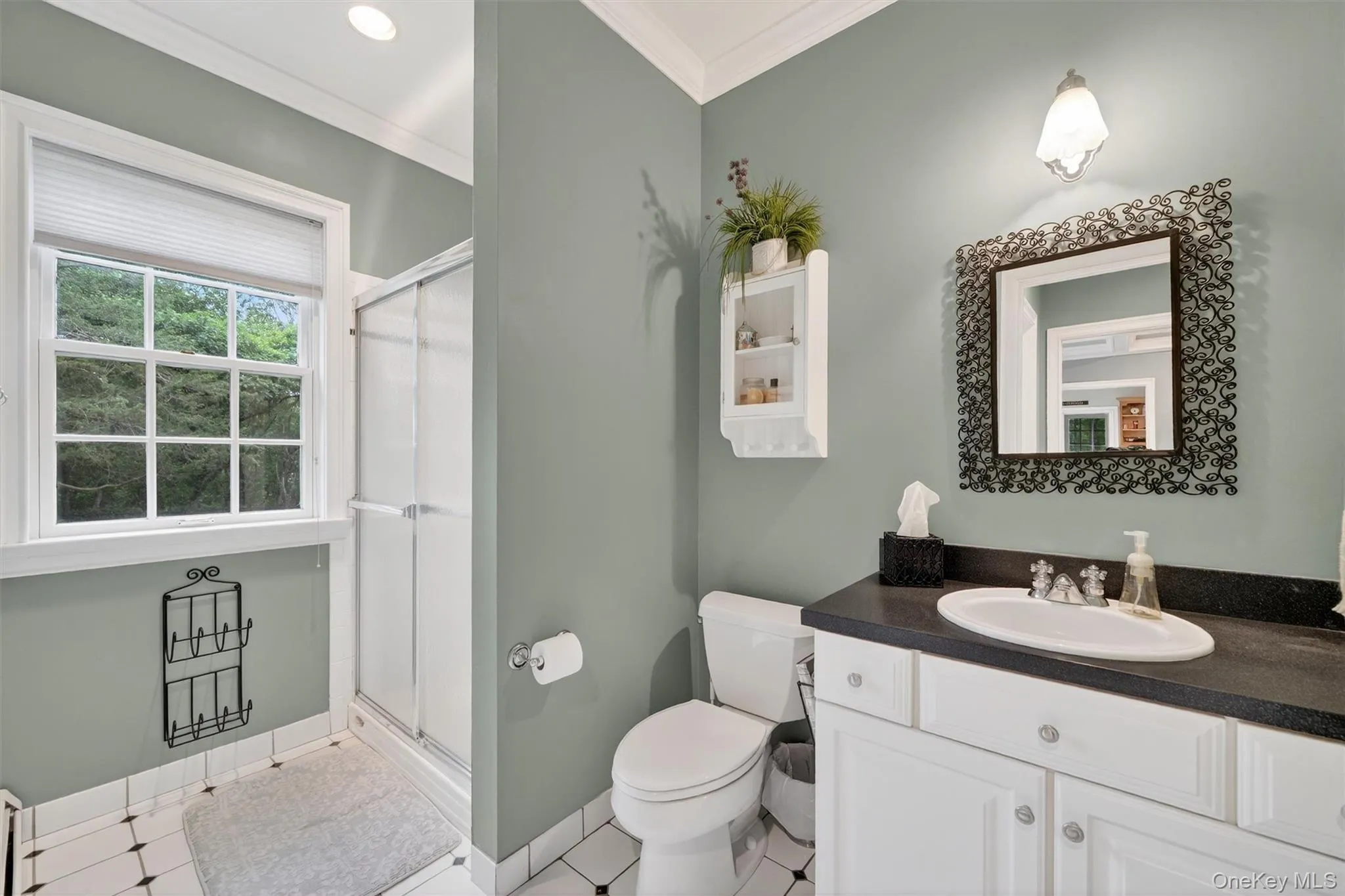 Full bathroom with crown molding, vanity, and a stall shower Full bathroom with crown molding, vanity, and a stall shower
