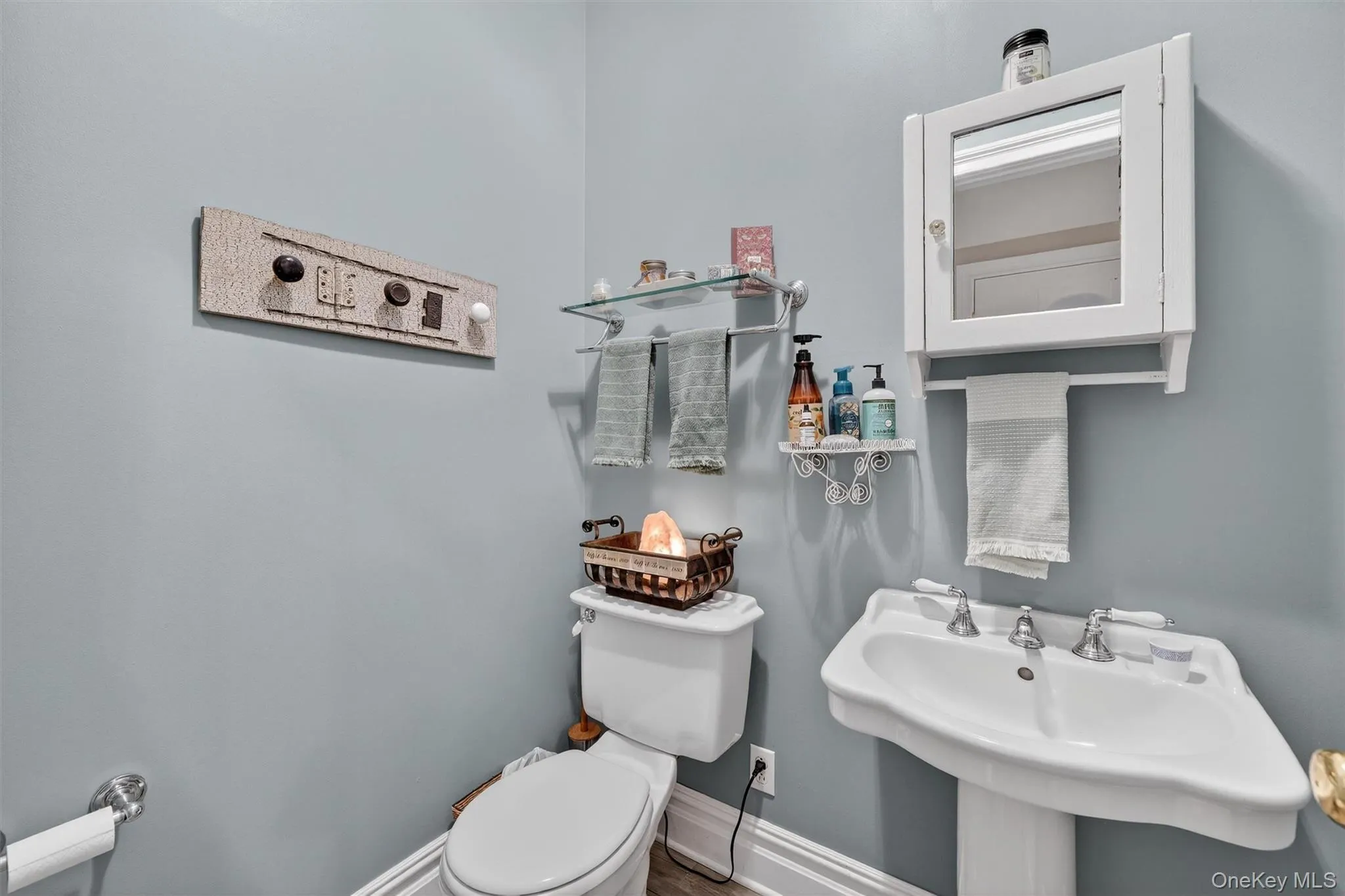 Half bathroom with toilet and a sink Half bathroom with toilet and a sink