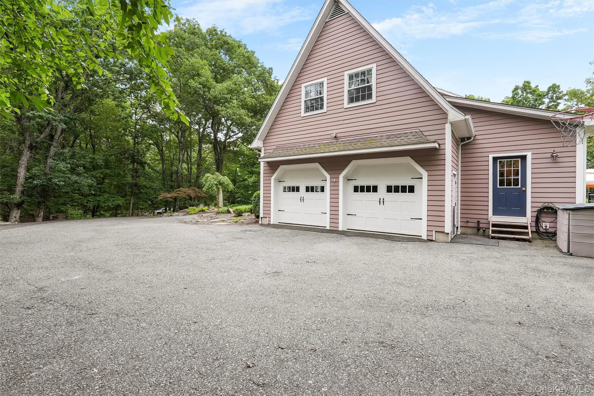 View of home's exterior featuring a garage and driveway View of home's exterior featuring a garage and driveway