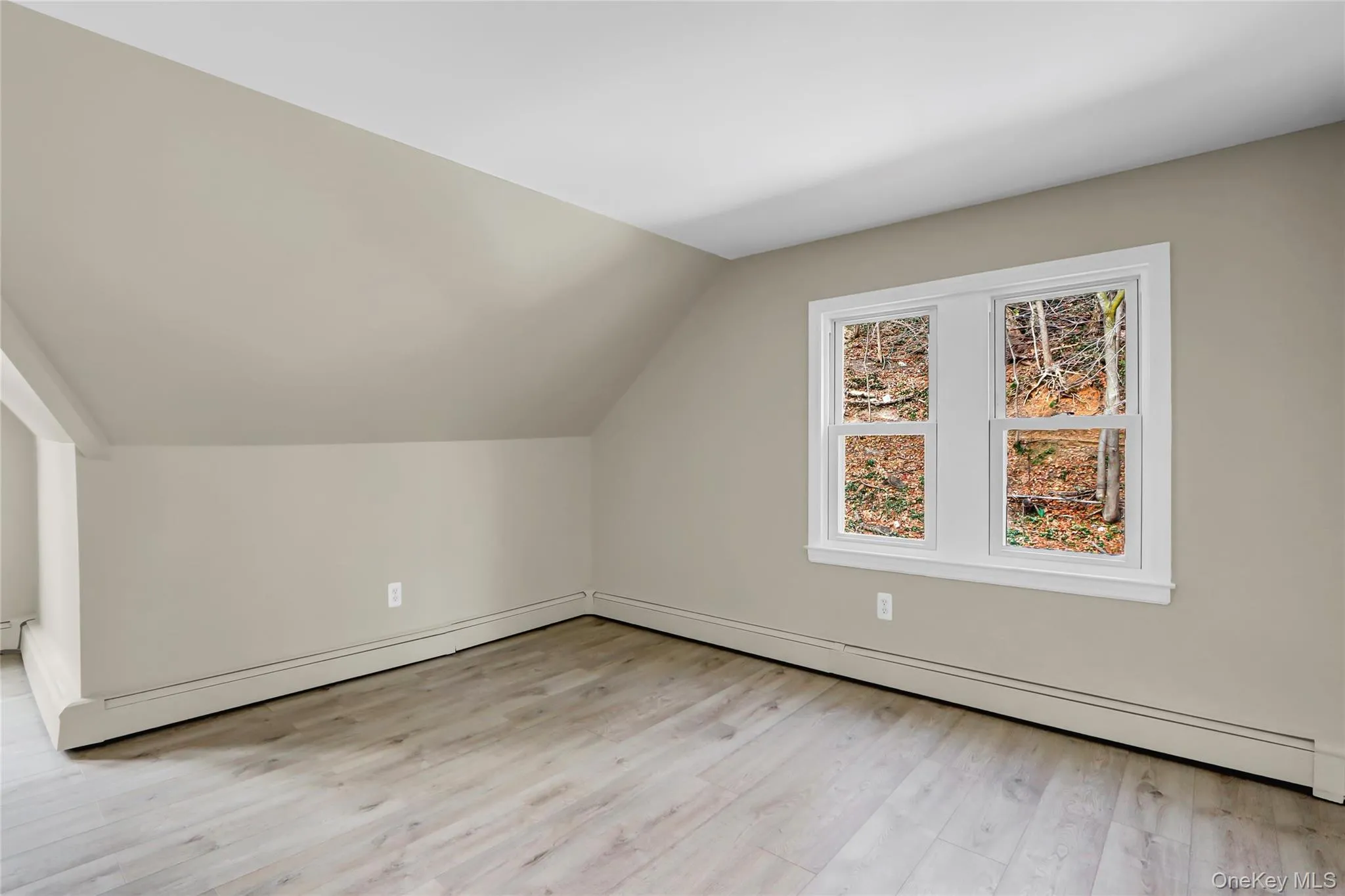 Bonus room with lofted ceiling and light wood-style flooring Bonus room with lofted ceiling and light wood-style flooring