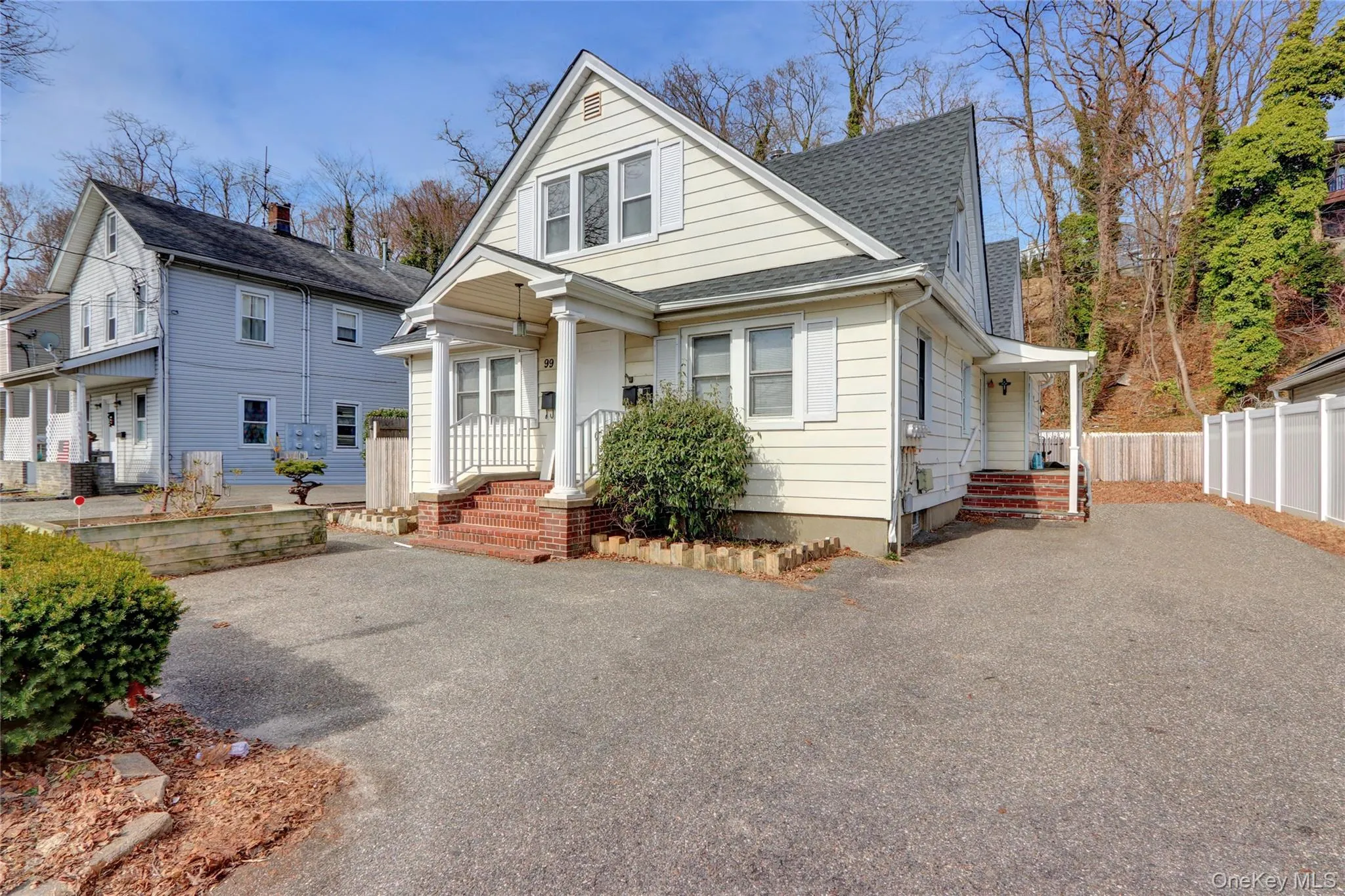Bungalow-style home featuring driveway, roof with shingles, and fence Bungalow-style home featuring driveway, roof with shingles, and fence
